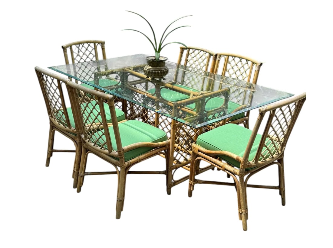 Set of six teak rattan dining chairs with a matching glass top table: Set of six teak rattan dining chairs with a matching glass top table. The 6 cushions are newly upholstered and brand new. DIMENSIONS: Table- 72"L x 42"D x 28.75"H. Chairs- 18.5"W x 20.5"D x 33.5"H