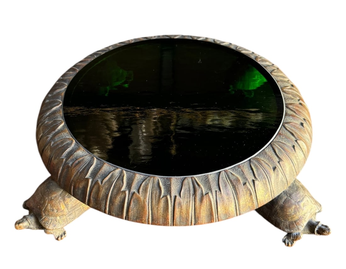 An antique bronze plant stand with turtle feet and a green glass center: An antique bronze plant stand with turtle feet and a green glass center. DIMENSIONS: 12.5"W x 12.5"D x 3.25"H