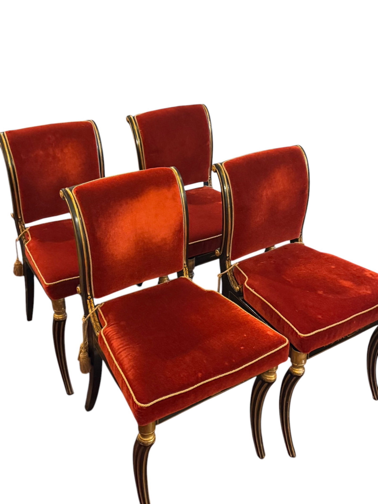 Set of 4 antique Regency caned and lacquered dining chairs upholstered in a red-orange Scalamandre: Set of 4 antique Regency caned and lacquered dining chairs upholstered in a red-orange Scalamandre mohair and accented with a gold cord trim and tassel tiebacks. The fabric naturally shows movement an