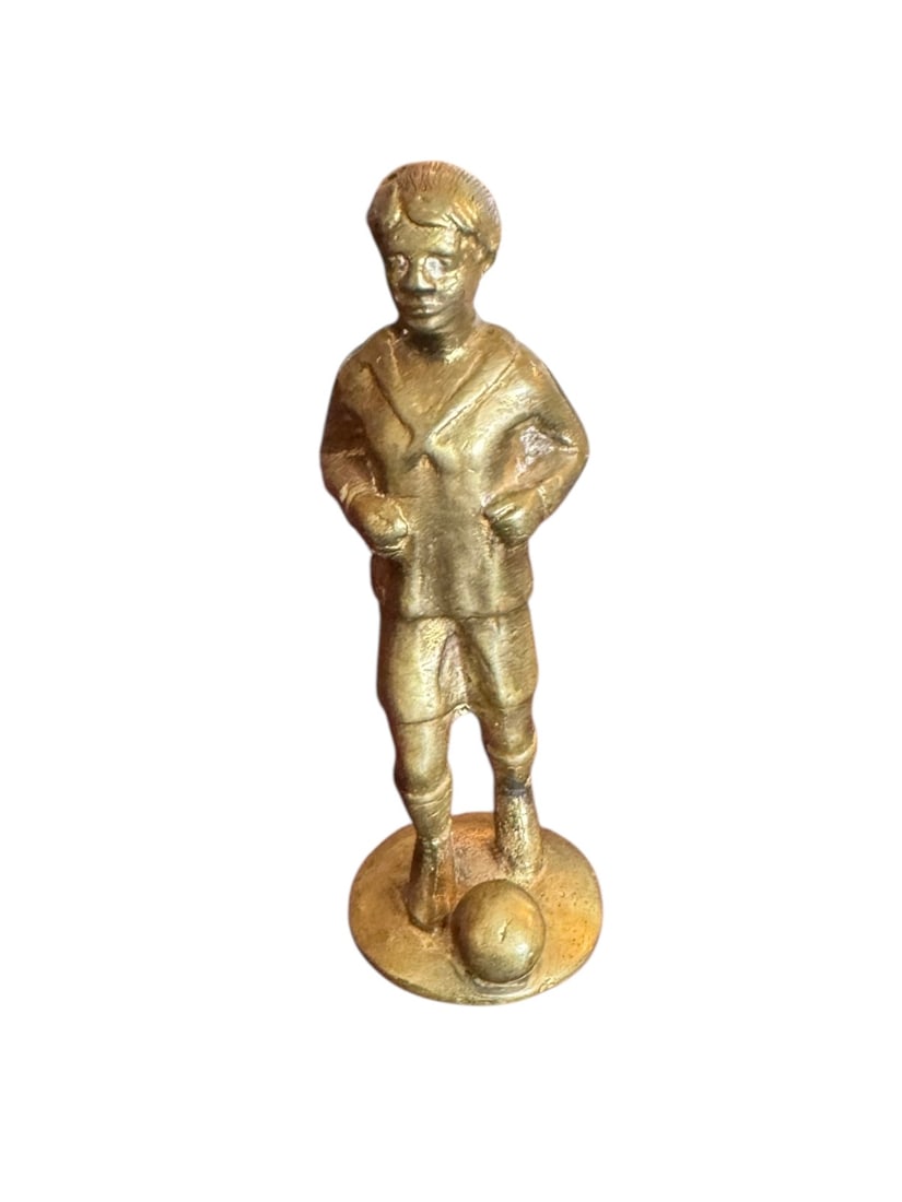 Boy playing soccer brass statue: Boy playing soccer brass statue. DIMENSIONS: 1.25"x 4"