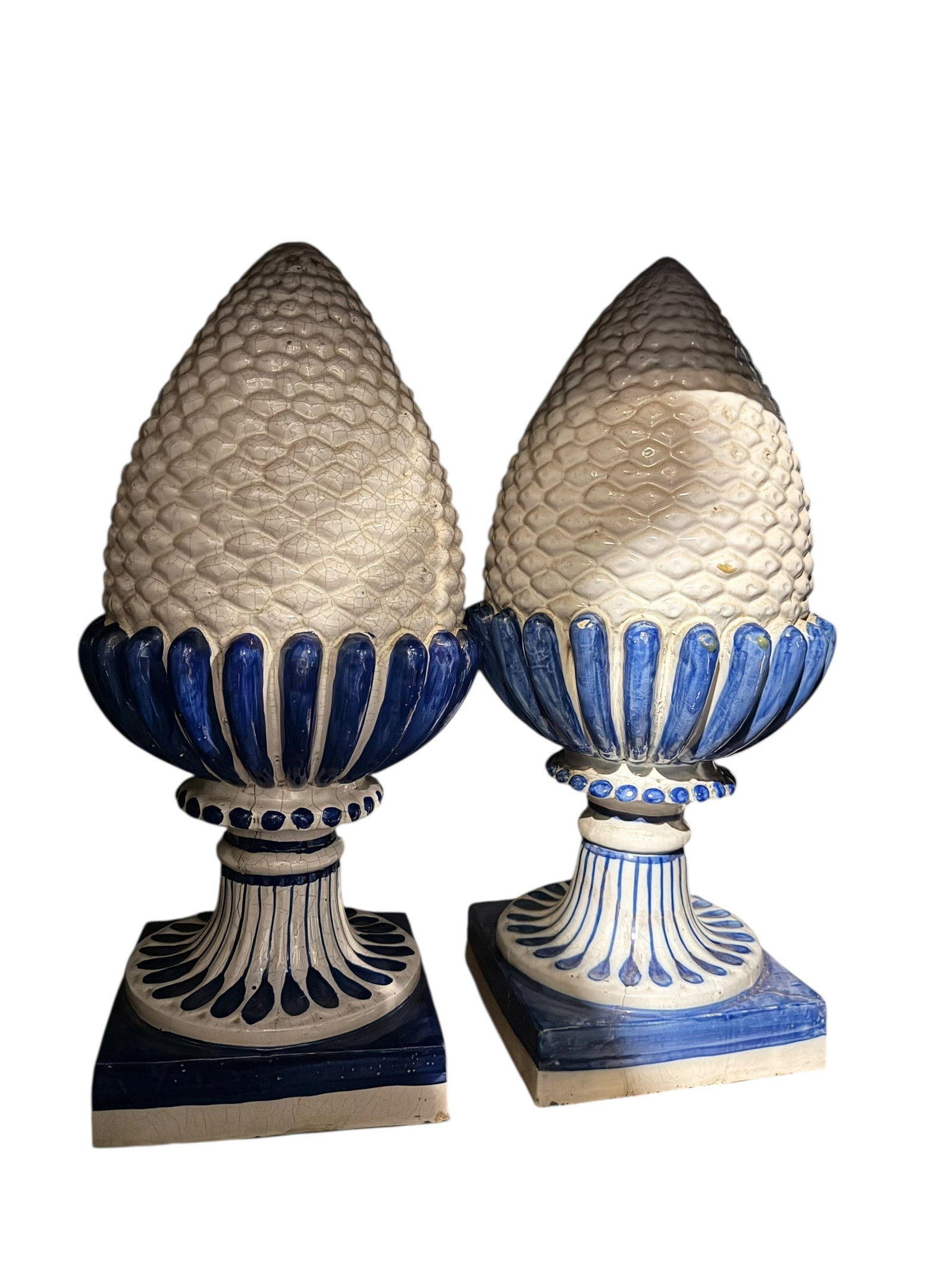 An exceptional pair of blue and white Delft pinecone statues: An exceptional pair of blue and white Delft pinecone statues. Each is slightly different. DIMENSIONS: 8.5"D x 22"H