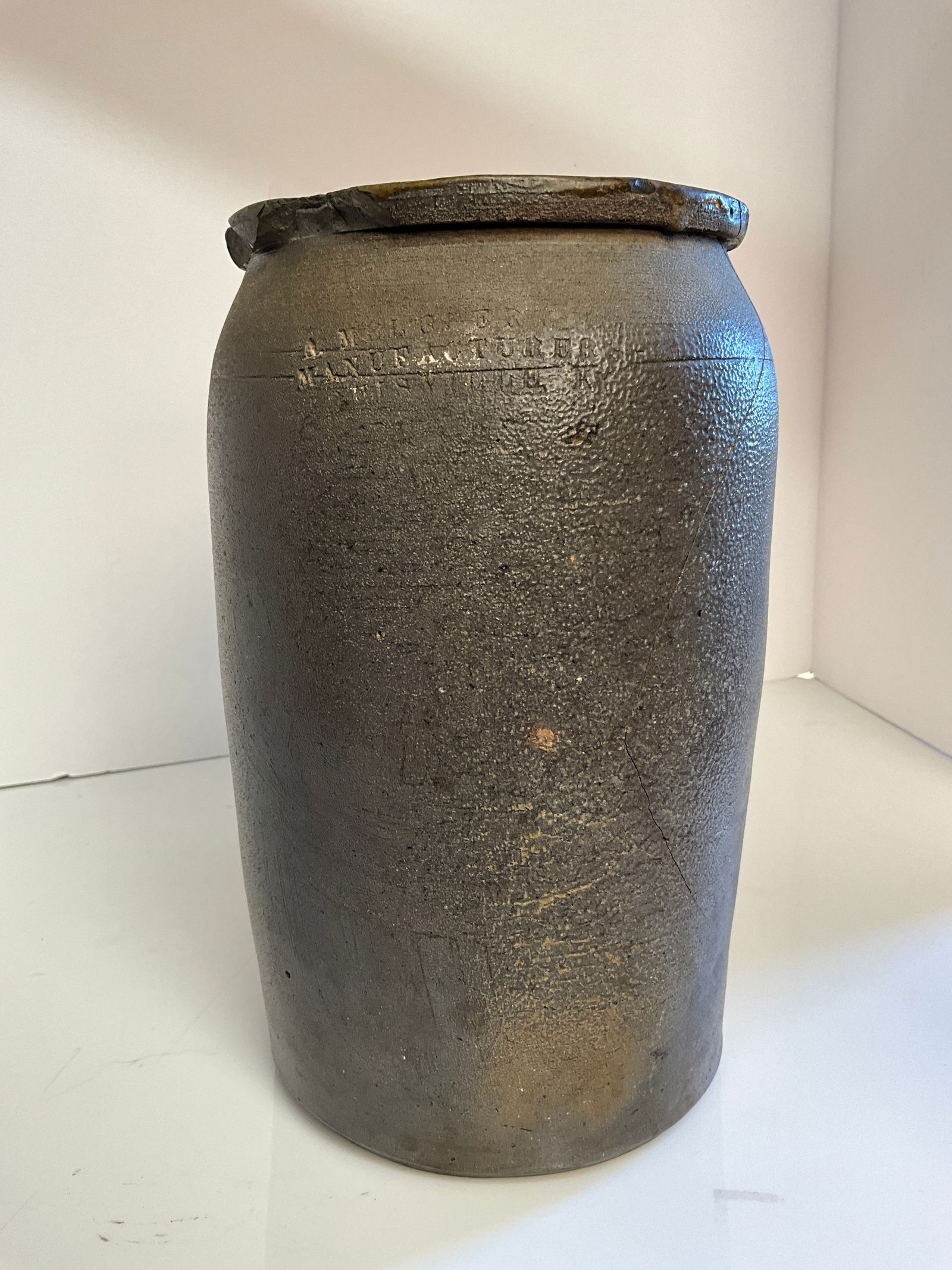 A. Melcher Stoneware Crock, Manufactured Louisville KY: Smaller size crock from Louisville Kentucky, A Melcher, Manufactured Louisville KY. Minor chips off the lip, however at some point a piece broke off the crock, a sizable piece and then it was glued ba