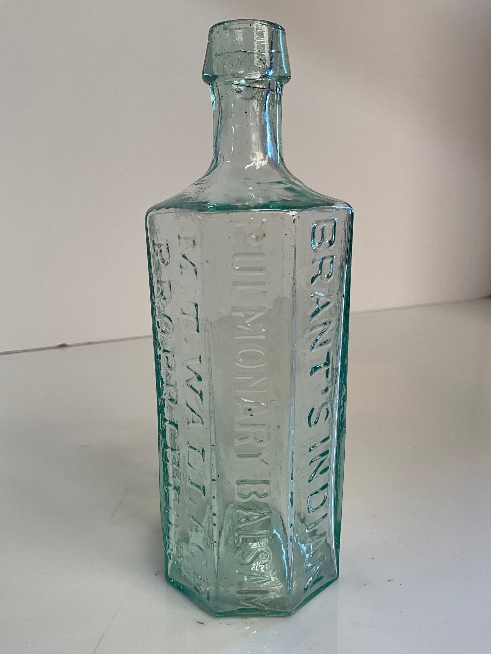 1850s Open Pontiled Brant's Indian Pulmonary Balsam, M.T. Wallace Proprietor: 1850s Open Pontiled Brant's Indian Pulmonary Balsam, M.T. Wallace Proprietor. A nice early medicine with an applied tapered top. Clean bottle with no damage and highly whittled. Bottle has very strong