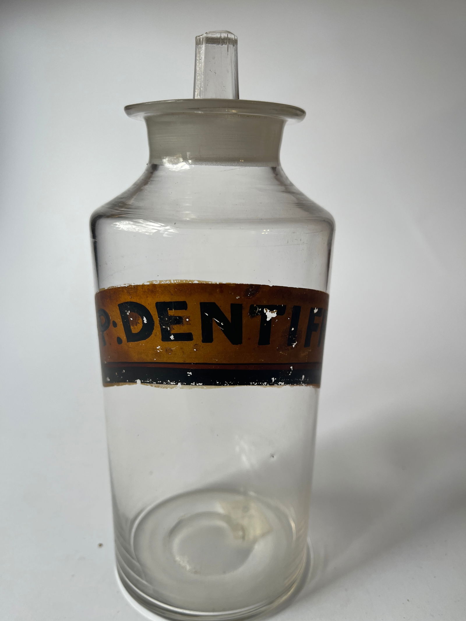 Early apothecary jar with label and lid. (1 of 4)