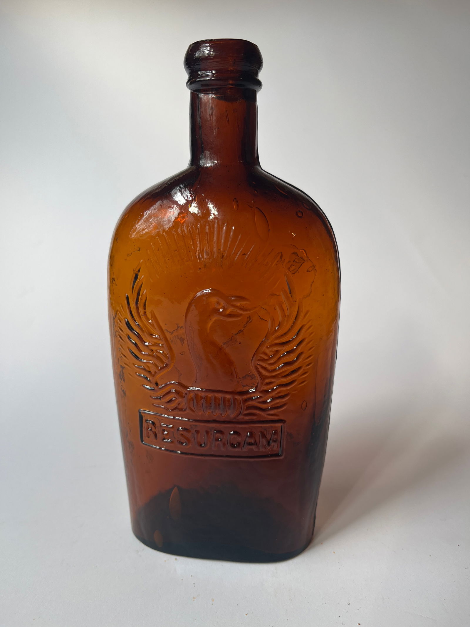 Pint amber RESURGAM BALTIMORE GLASSWORKS Flask, Open Pontil: Pint amber RESURGAM BALTIMORE GLASSWORKS Flask, Open Pontil. Nice crude flask. Nice condition exept for a chip on base edge.