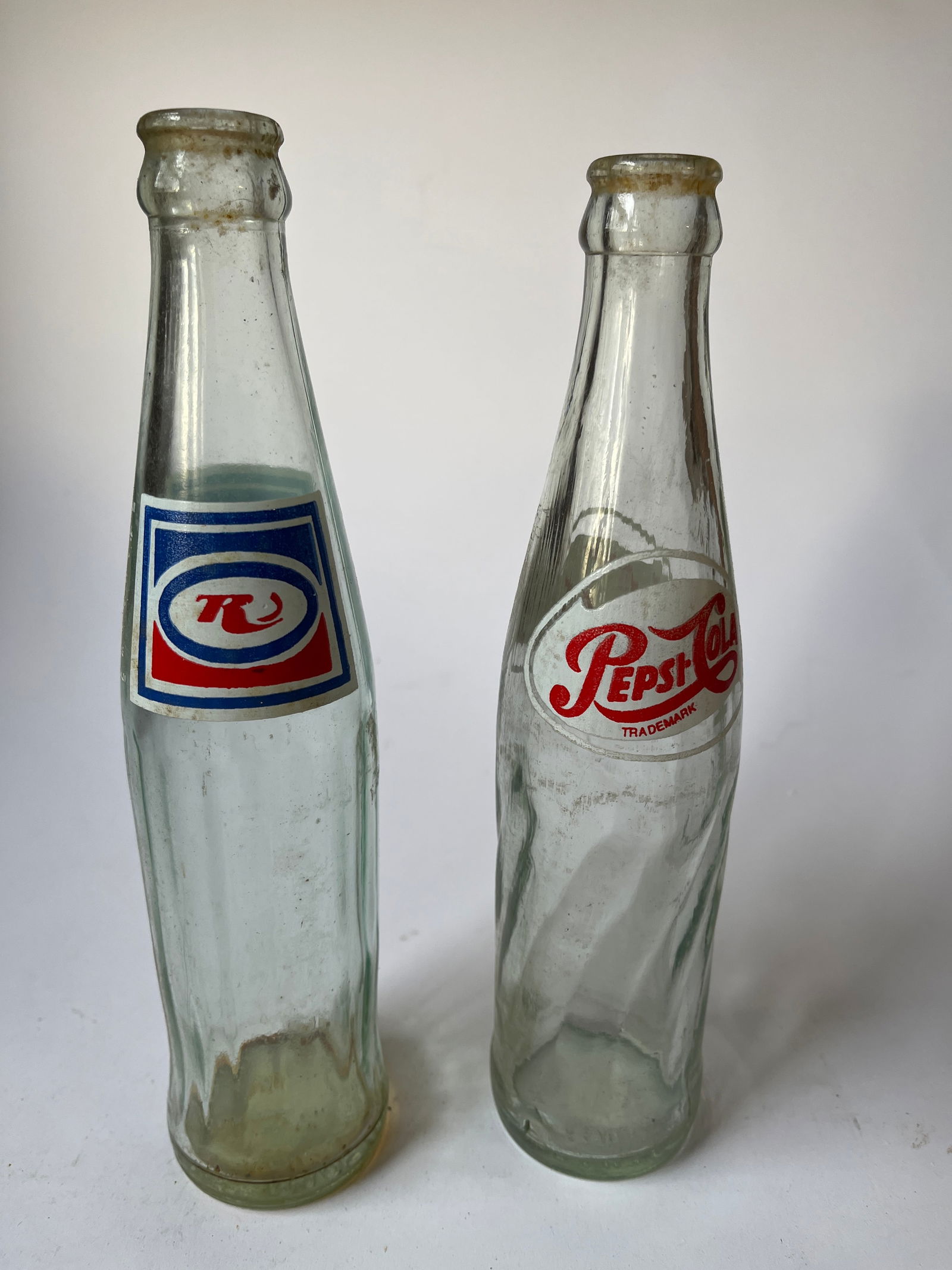 Lot of 2 foreign pop bottles, One is a Pepsi-Cola.: Lot of 2 foreign pop bottles, One is a Pepsi-Cola from IRAQ. The other resembles a RC but no sure. This bottle is from IRAN.