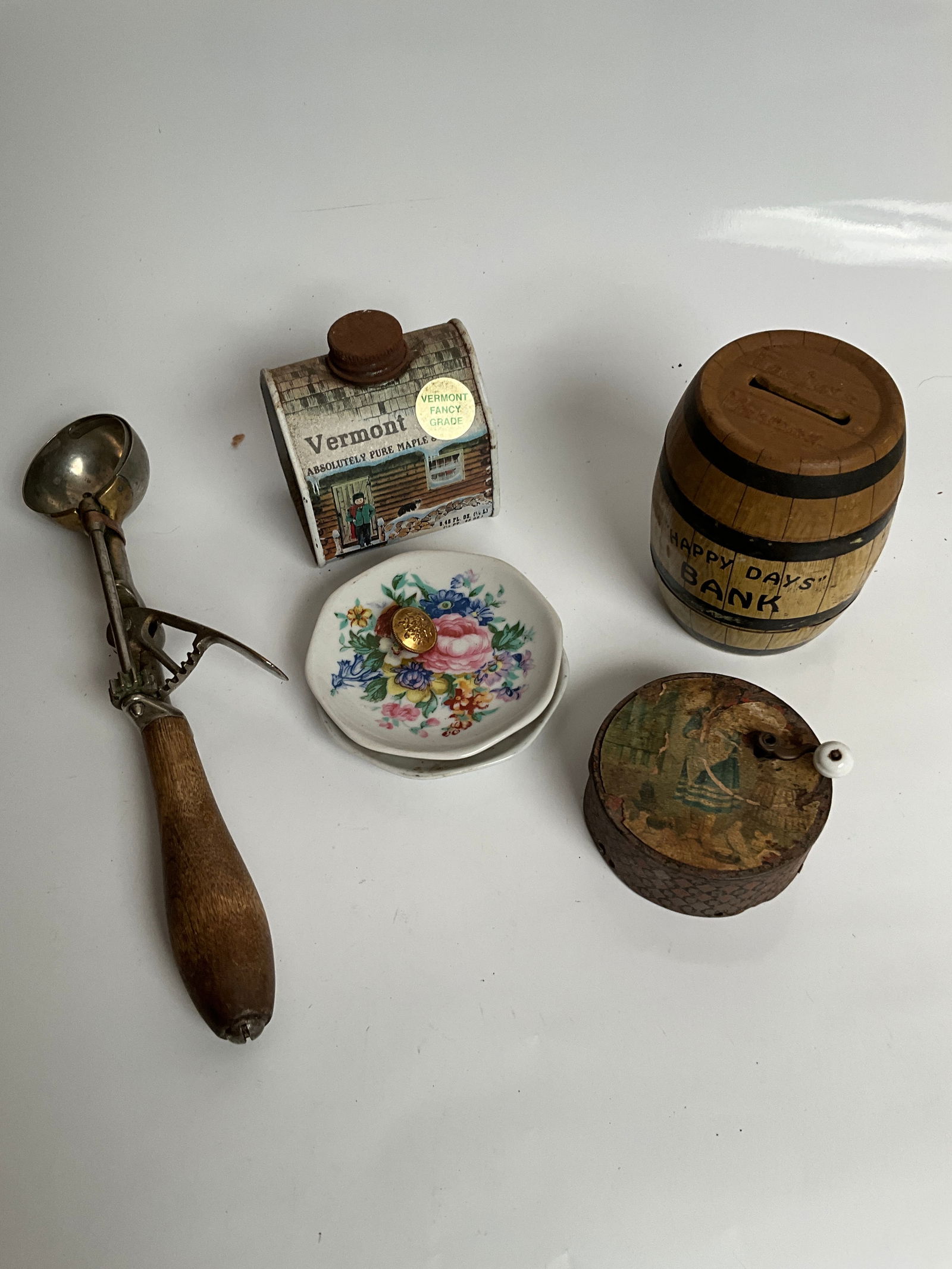 Lot full of miscellaneous items: Here is a small lot of items, including, ice cream scooper with brass parts made by Gilcrest. Vermont pure maple syrup 10. A happy days. And a Victorian wind up toy that still works with great Litho w