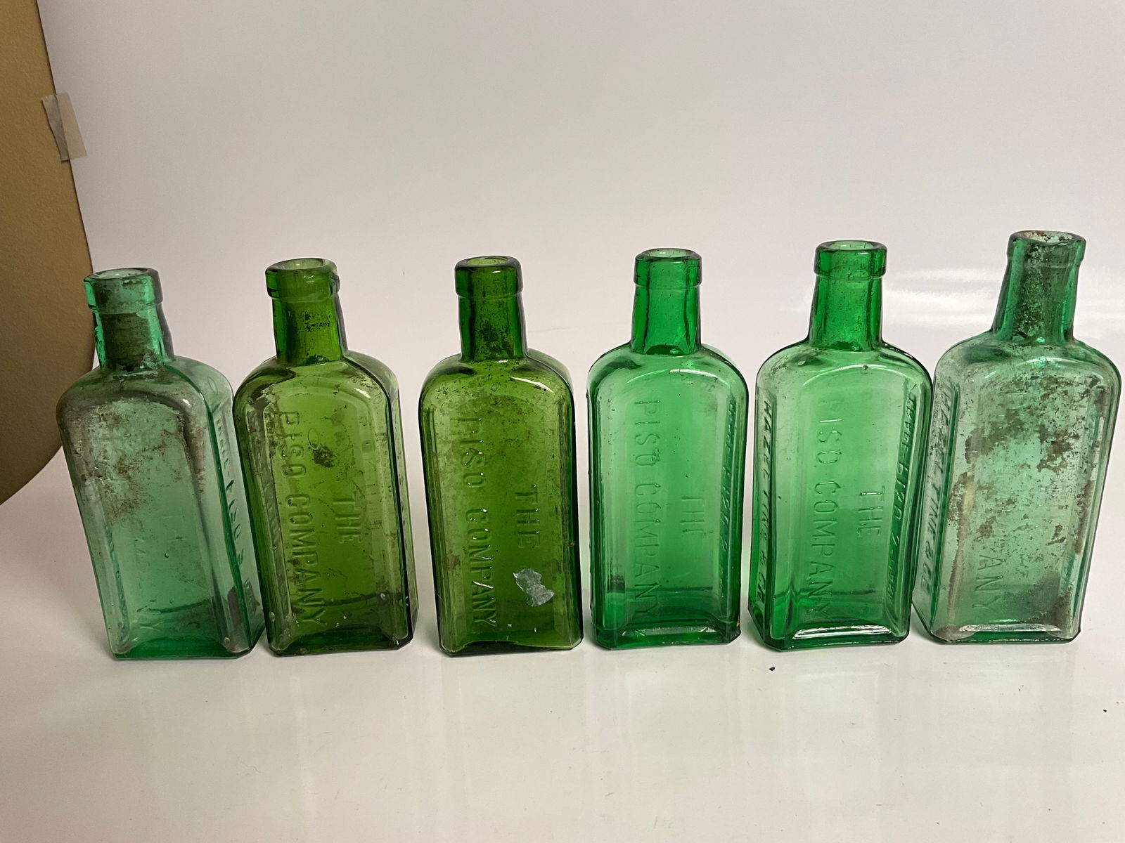 6 different green colored Pisos Company medicine bottles. Six to choose from. (1 of 8)