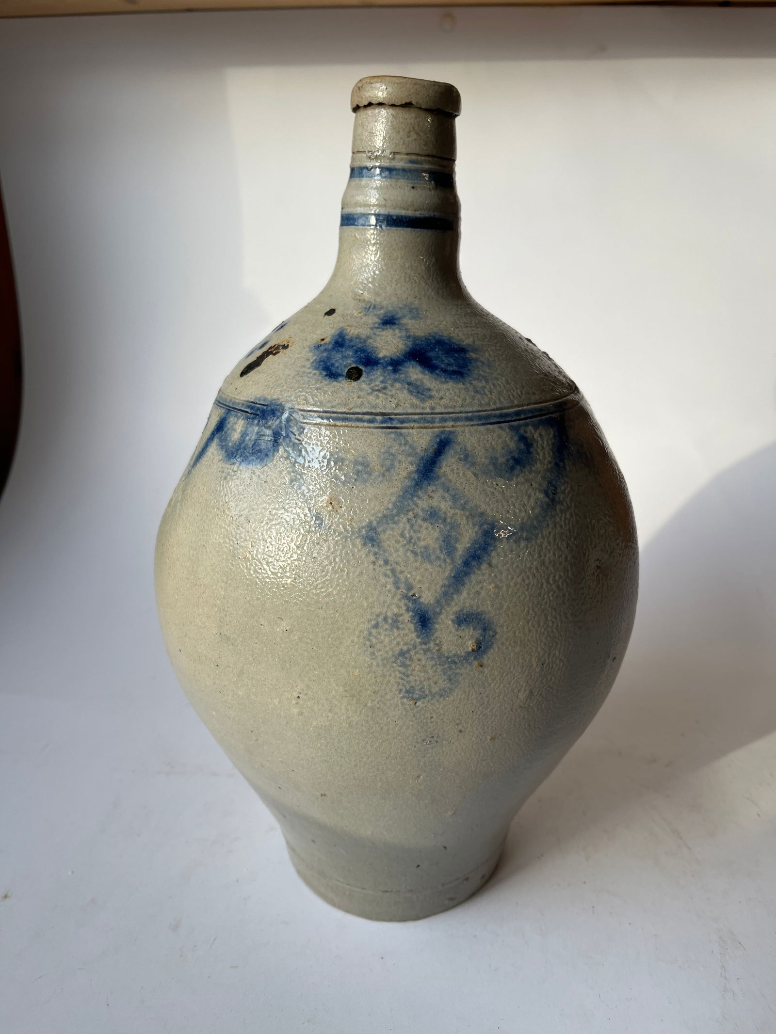 Gray salt glazed ovoid jug w/ blue decorations.: Gray salt glazed ovoid jug w/ blue decorations. Early form, nicely decorated. Not sure of origin. Great condition. One small chip on base edge.