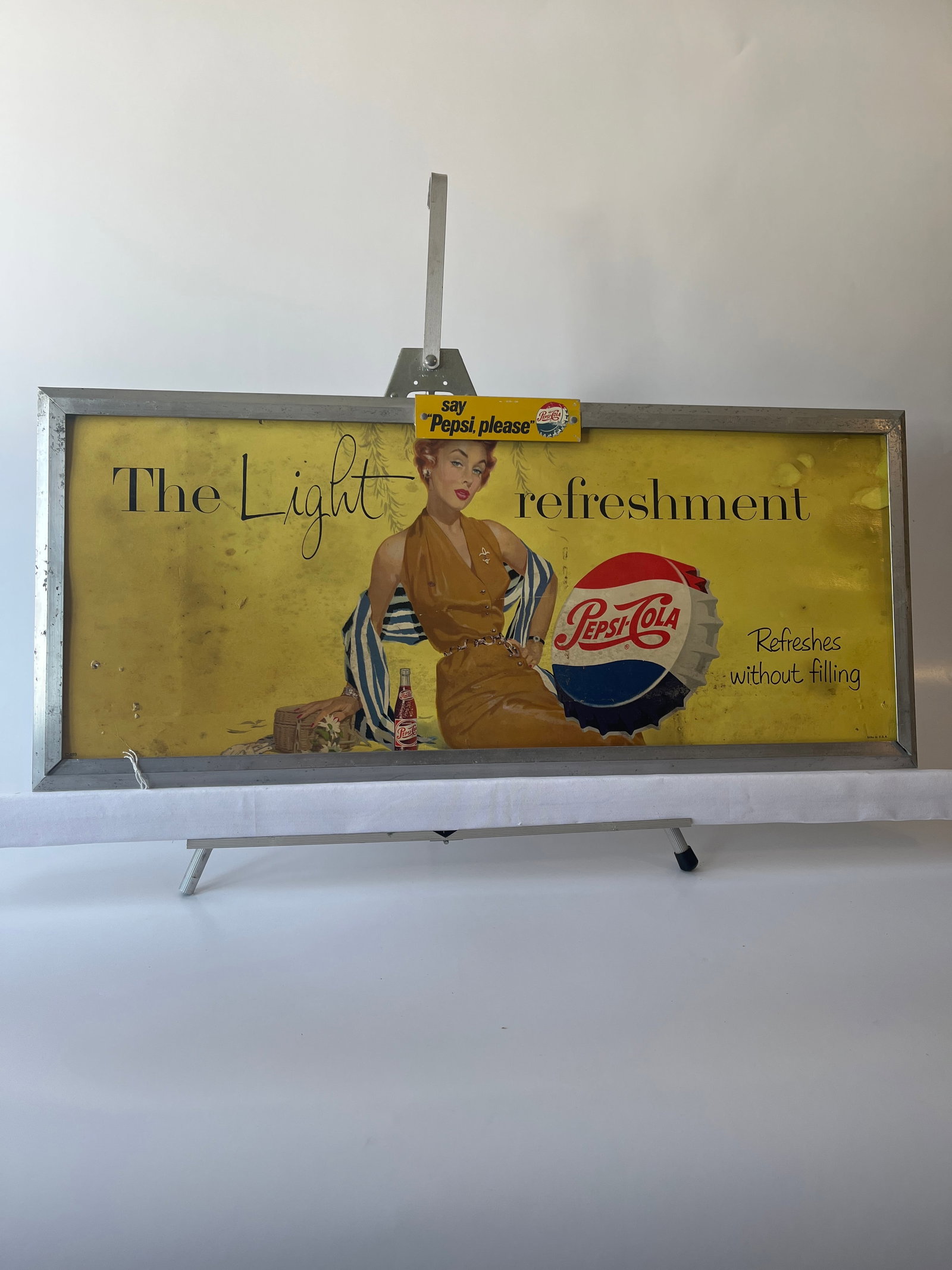 The Light Refreshment Pepsi-Cola 13" X 29": The Light Refreshment Pepsi-Cola 13" X 29" Aluminum frame with extra Say Pepsi Please metal plaque rivetted in place. Sign is dirty.