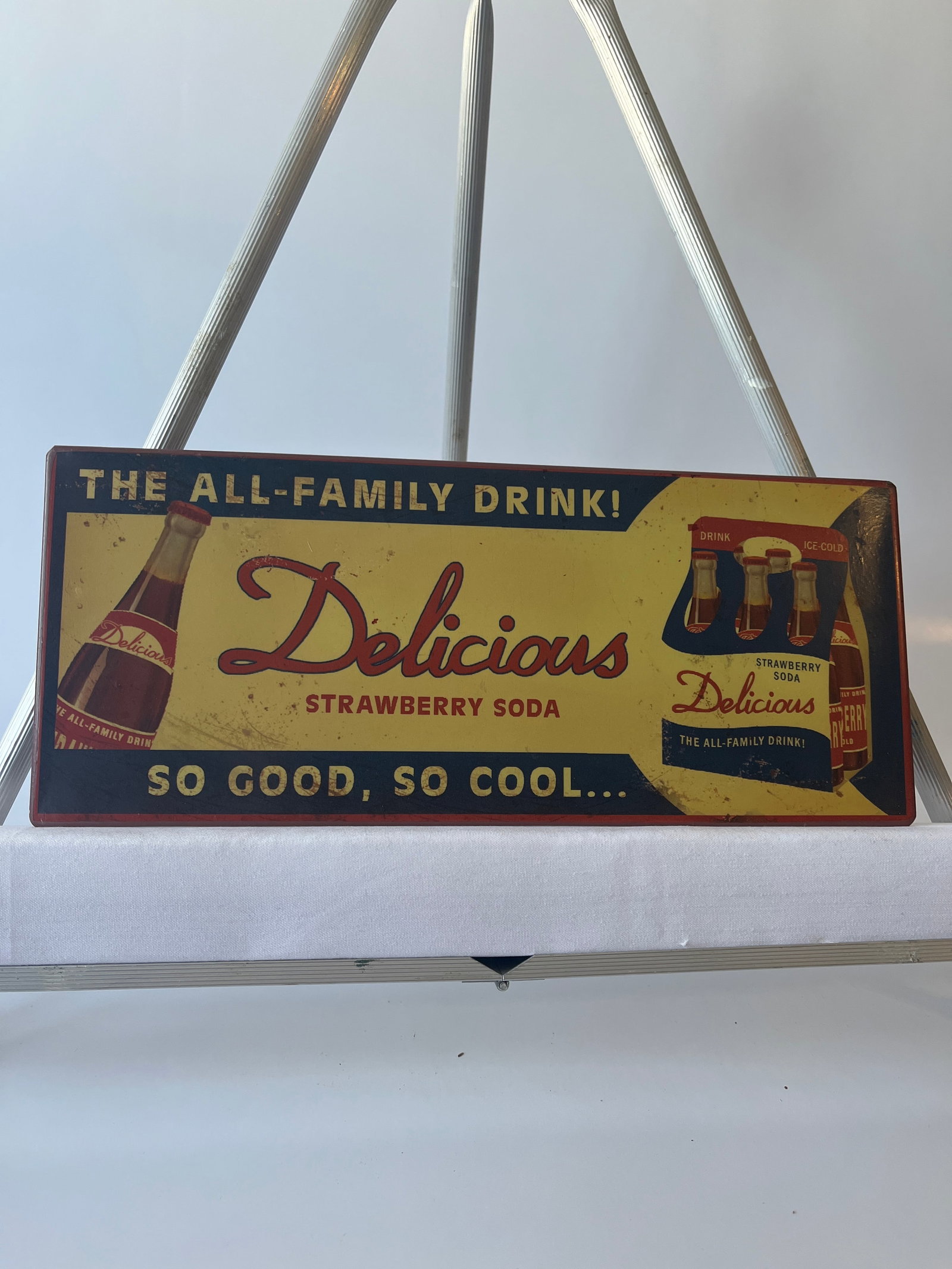 Delicious Strawberry Soda metal sign. 5" X 12".: Delicious Strawberry Soda metal sign. 5" X 12". Has metal tabs welded on back for haning. Unsure of age.