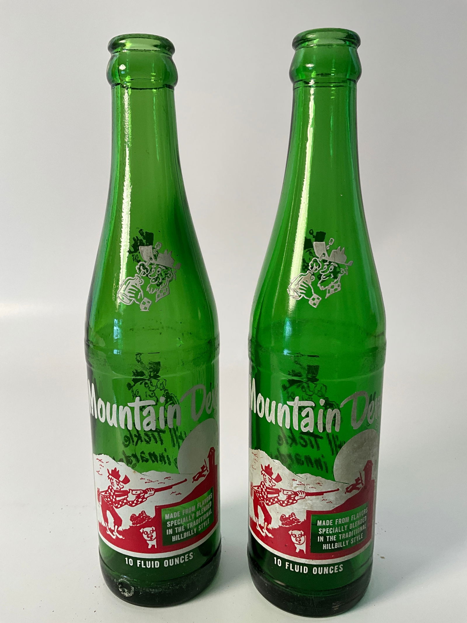 Lot of Two Hillbilly Mountain Dew Bottles: Lot of two Hillbilly Mountain Dew bottles. No names.