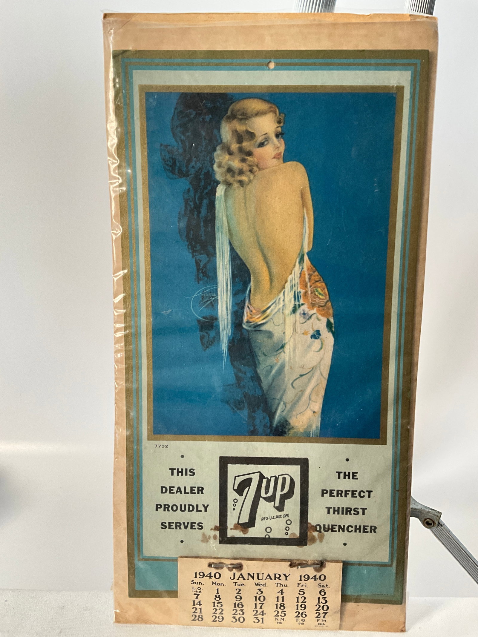 1940's 7UP Advertising Calendar with Beautiful Woman, Art by Rolf Armstrong: 1940's 7-UP advertising calendar. All months seem to be in tact on the advertisement. THIS DEALER PROUDLY SERVES and THE PERFECT THIRST QUENCHER are written on each side of the 7UP logo. Some staining