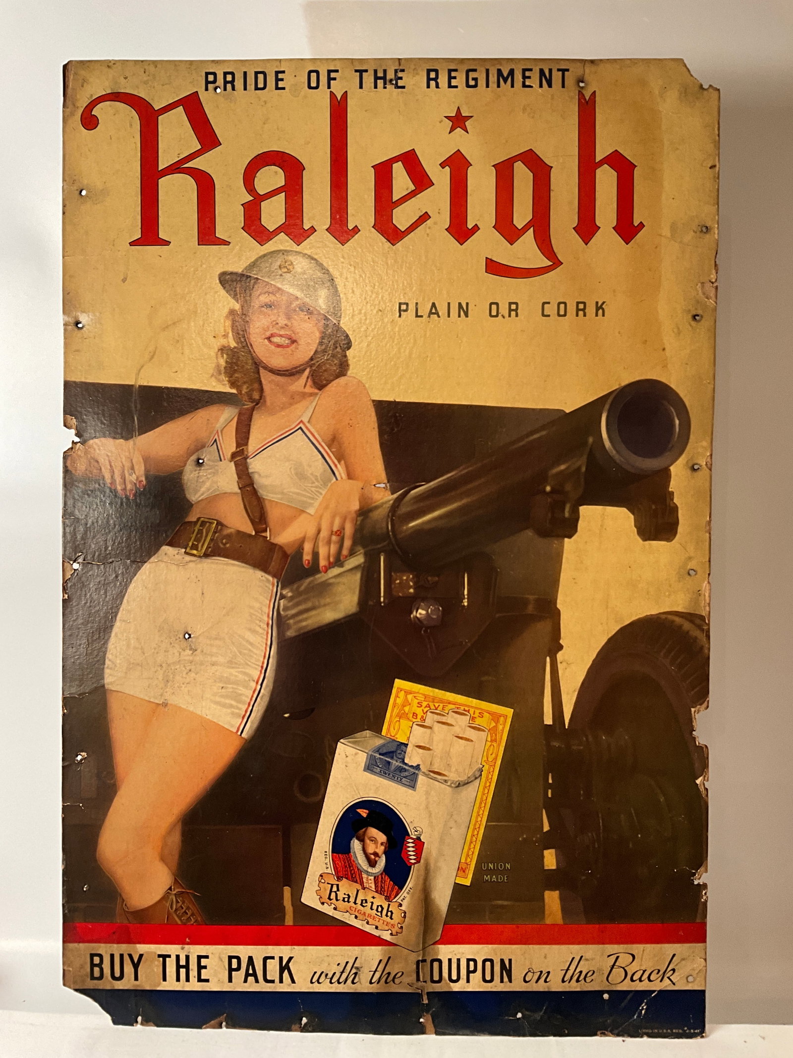 WW2 Pin Up Girl Raleigh Cigarettes Advertising Sign: WW2 Raleigh Cigarettes advertising sign depicting pin up leaning agains a cannon. Pride of the Regiment. Raleigh Plain or Cork. Pin up is wearing red, white, and blue, along with a helment. BUY THE PA