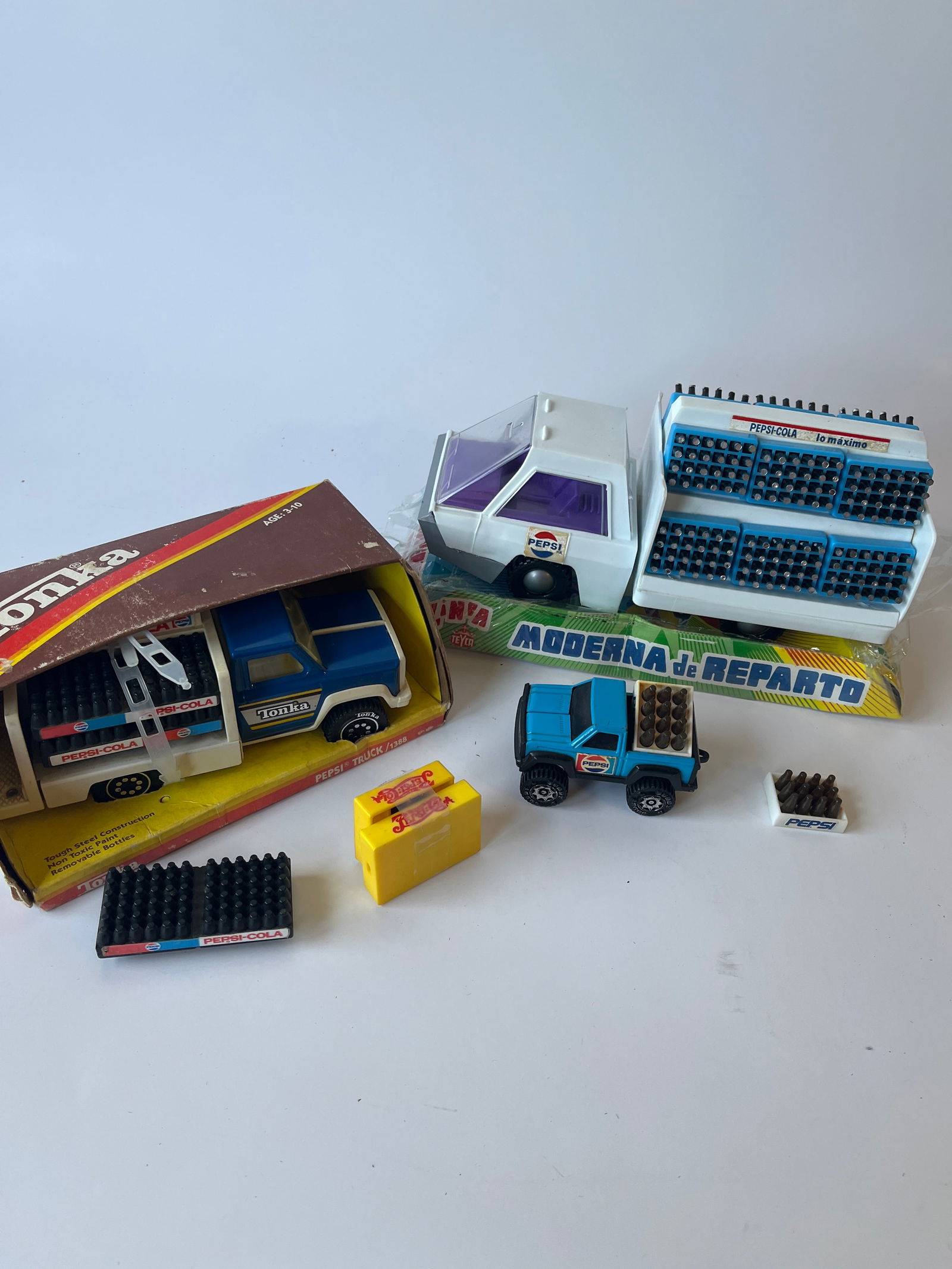 Lot of 3 Pepsi toy trucks.: Lot of 3 Pepsi toy trucks. One is a metal Tonka, the other 2 are plastic. Extra Pepsi cases are included.