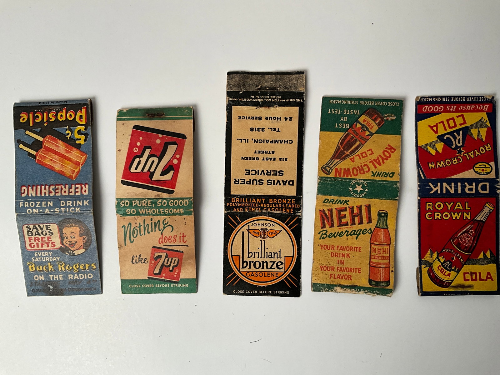 Lot of 5 Advertsing Matchbooks, 3 soda Pop, 1 Popsicle and 1 Brilliant Bronze Gasoline: Lot of 5 Advertsing Matchbooks, one Royal Crown, one Nehi, one 7up, one popsicle and one brilliant bronze gasoline. Only the 7Up retains the matches, the rest have been pulled.