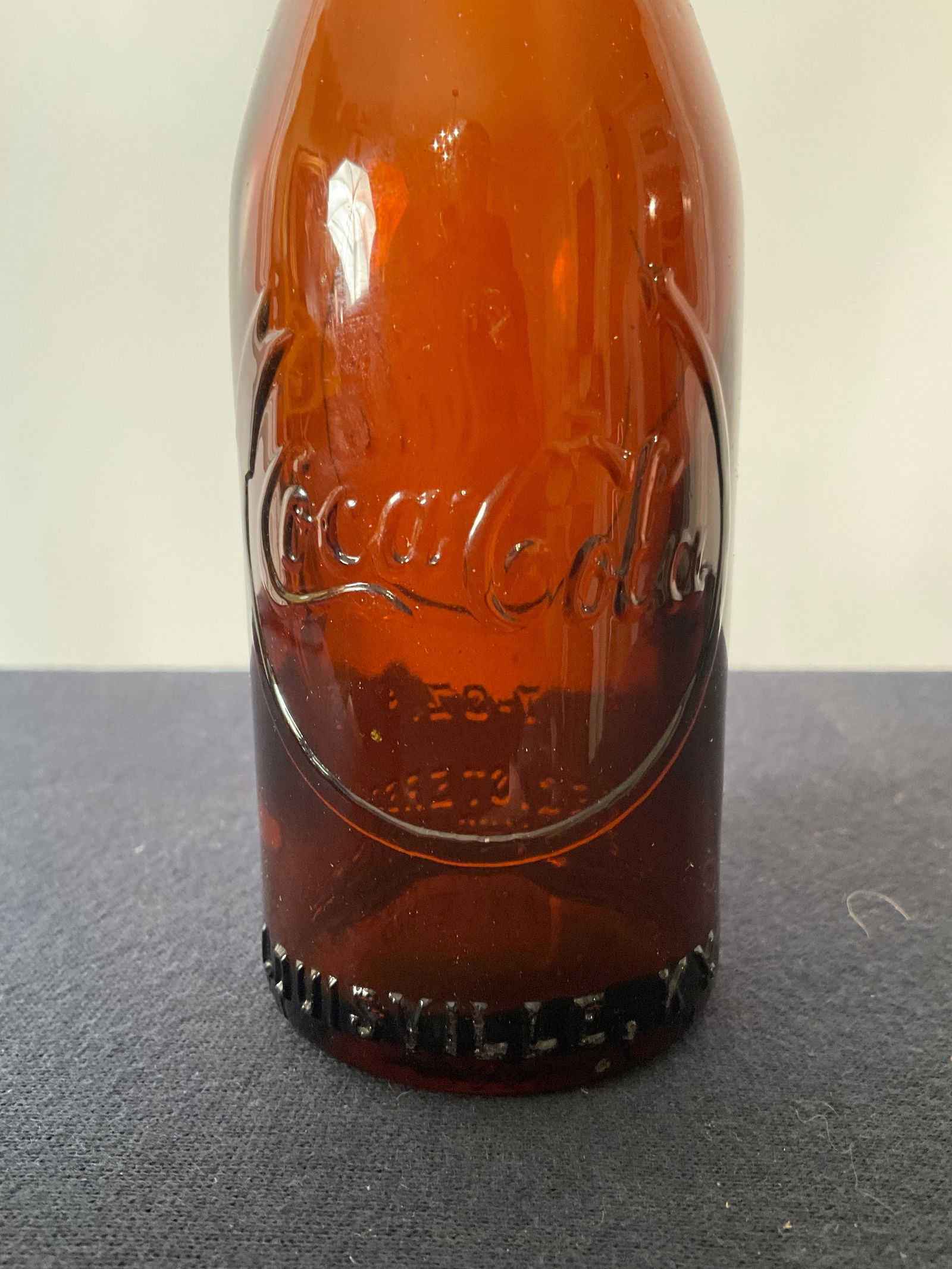 Straight Side Coca Cola Bottle with Horseshoe arrow, embossed Louisville Kentucky.: Straight Side Coca Cola Bottle with Horseshoe arrow, embossed Louisville Kentucky. This bottle has very strong embossing while most of these don't. Clean bottle, no damage. Embossed Coca-Cola with an