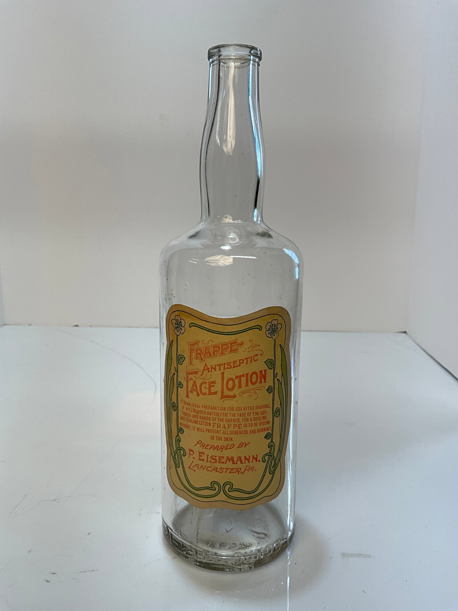 Illinois Glass Company Sample Bottle with Frappe Antiseptic Face Lotion, P. Eisemann PA. Label,: Illinois Glass Company, Alton Illinois Sample Bottle with Frappe Antiseptic Face Lotion, P. Eisemann, Lancaster PA. Label. Illinois Glass Company's Sample sticker is on the back and it's 100% complete