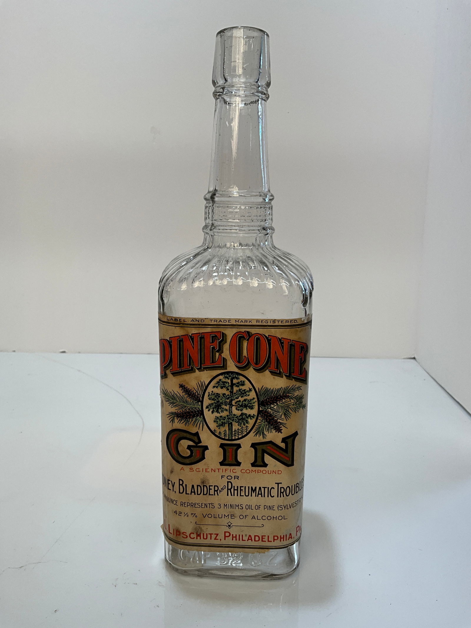 Pine Cone Gin bottle with 95% label, L.L.Lipschutz, Philadelphia, PA. Clear Bottle with Tooled Lip. (1 of 7)