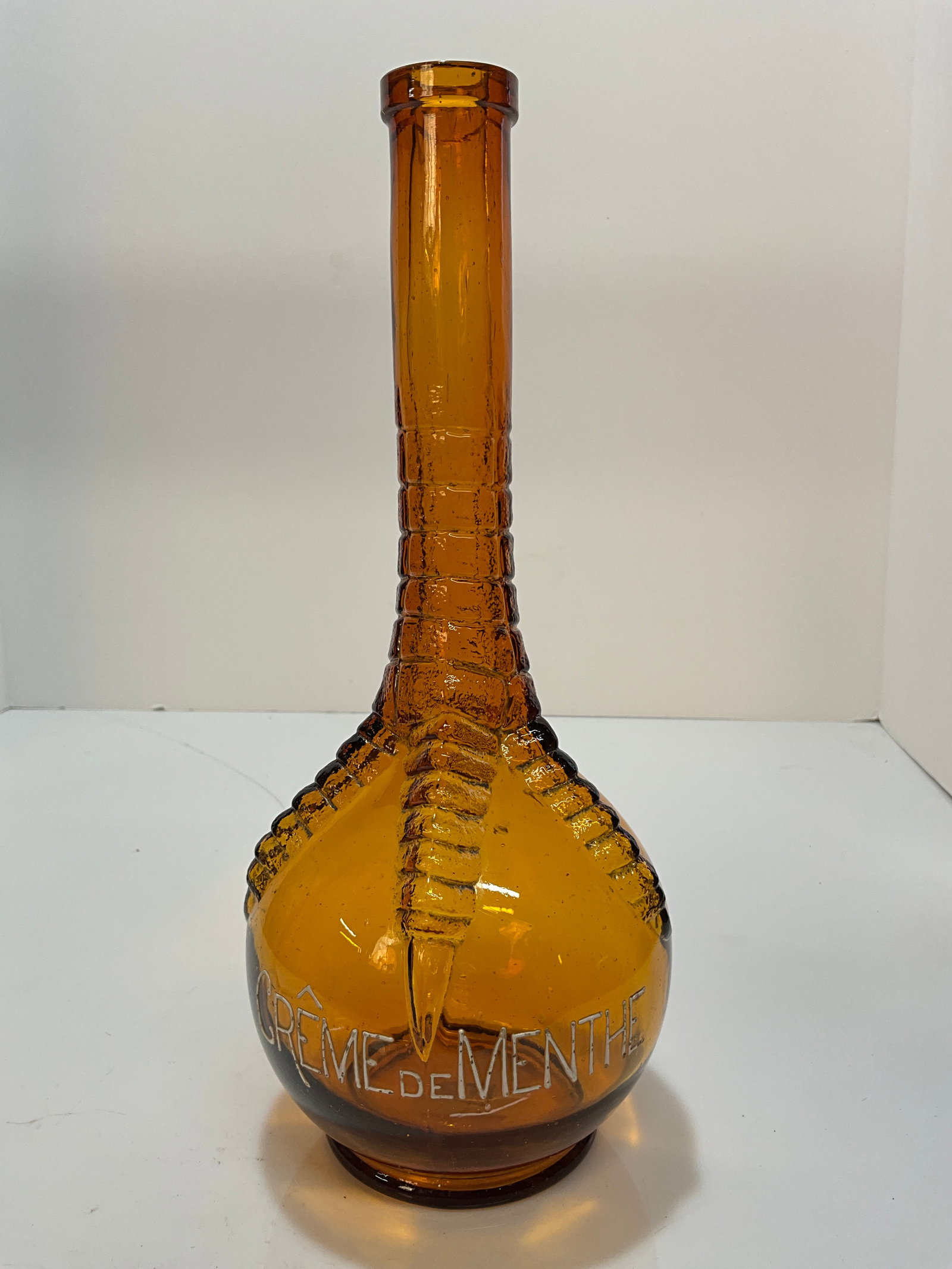 Creme De Menthe Amber Ball and Claw Bottle, Made by Hemingray Glass Co.: A nice light amber bottle, Creme De Menthe Amber Ball and Claw Bottle, Made by Hemingray Glass Co. These bottles are in a fantastic mold, with a Claw holding onto a ball with a banded lip. This is a f