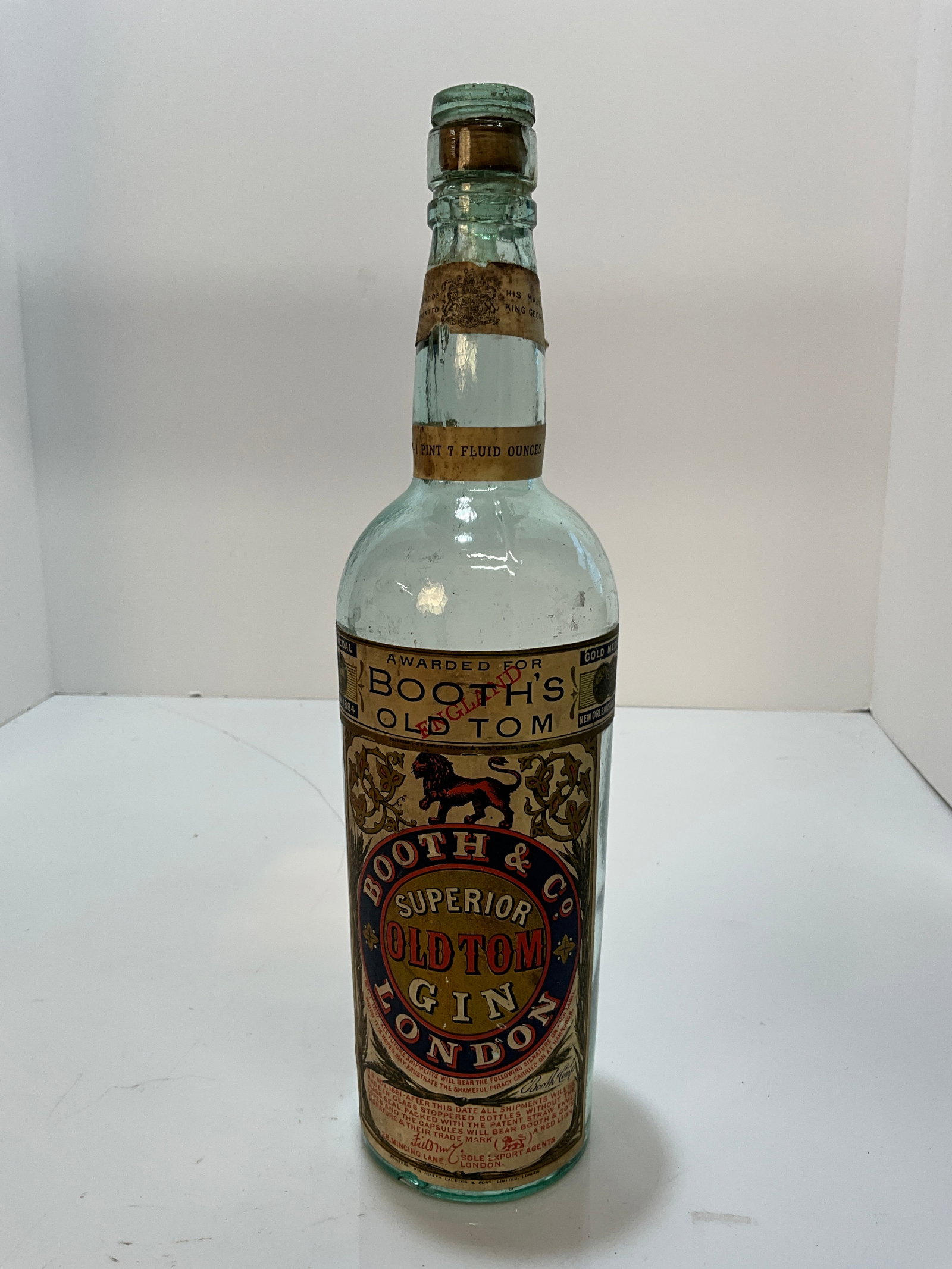 Booth & Co. Superior Old Tom Gin London Bottle with a Full Label.: A bottle with a full labels, Booth & Co. Superior Old Tom Gin London Bottle. The bottle has no damage and the label is complete. A slick bottle with a super graphics on the label. Bottle also retains 