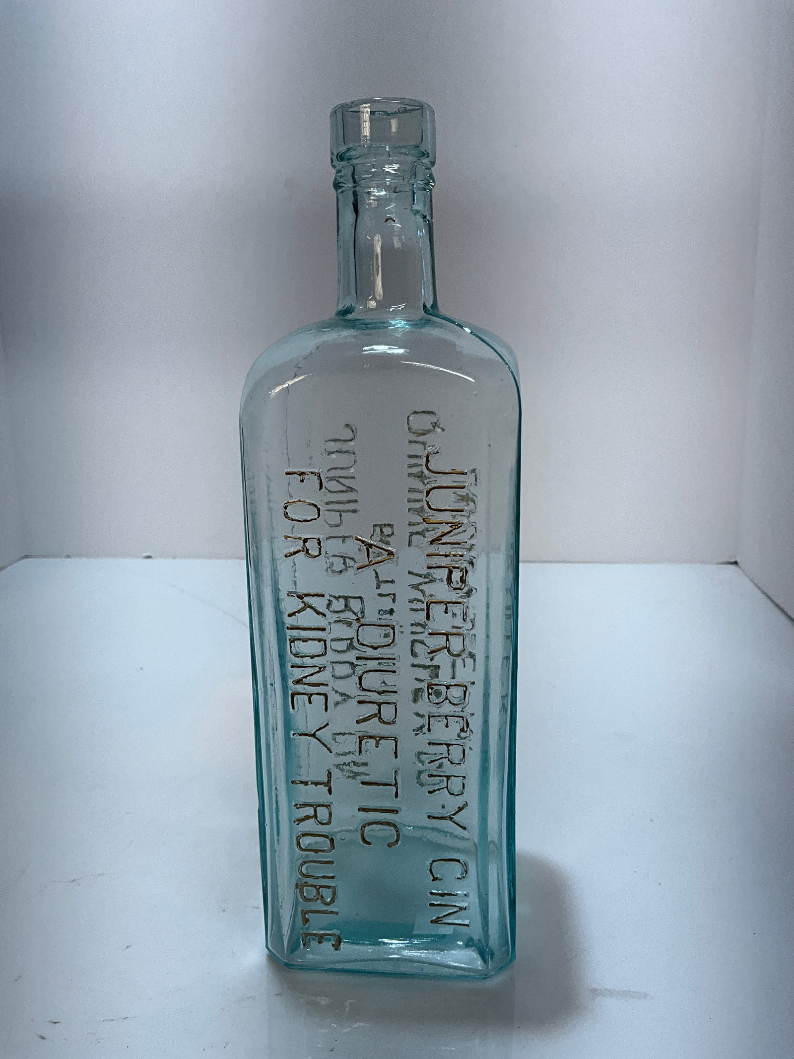 Juniper Berry Gin, Bottled by Quinine Whiskey Co. Louisville, KY., Kentucky: A square Aqua bottle Juniper Berry Gin, Bottled by Quinine Whiskey Co. Louisville, KY. embossed on one side. On the reverse panel is embossed, Juniper Berry Gin, A Diuretic for Kidney Trouble. A hard 