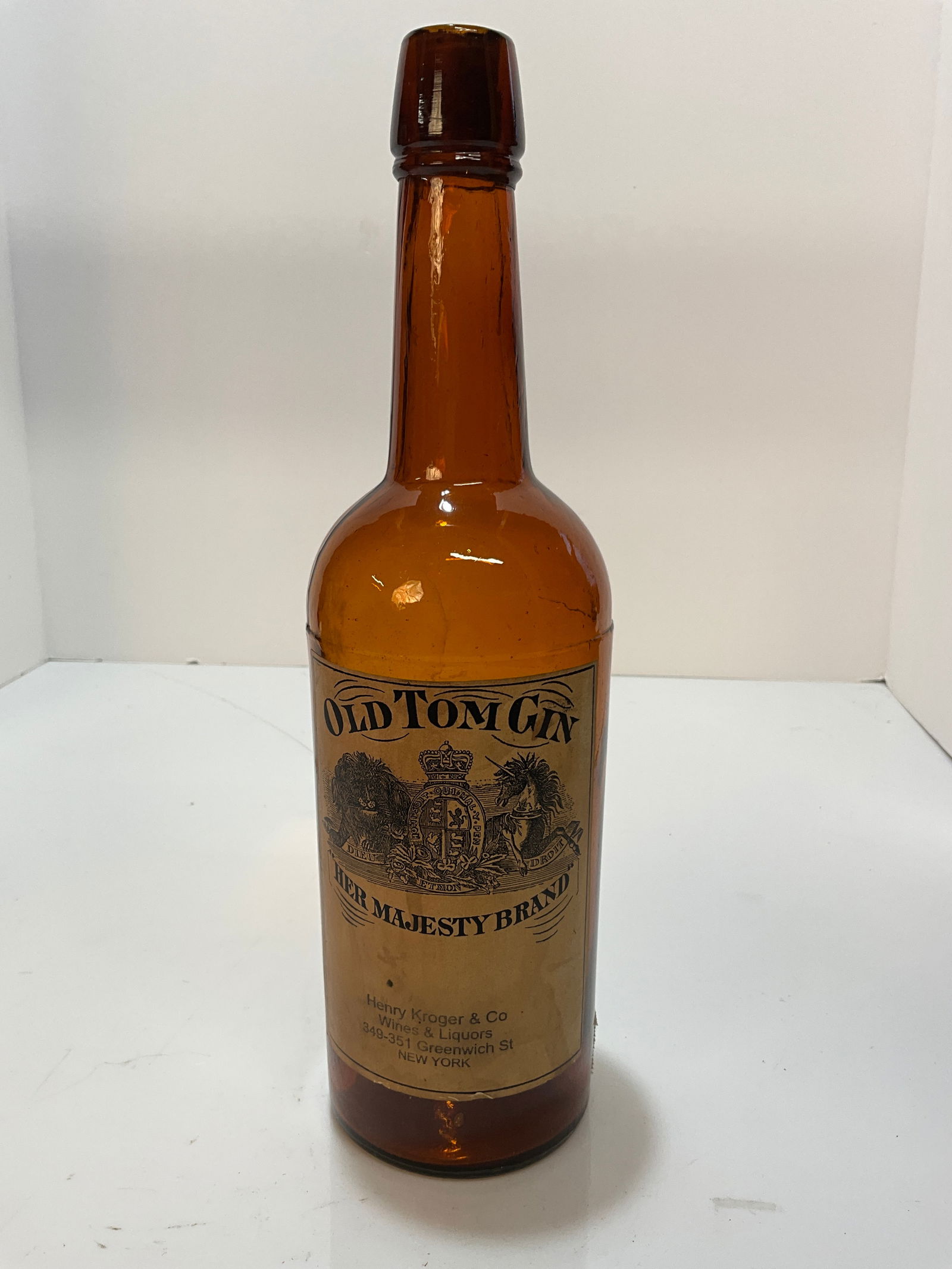 Old Tom Gin, Her Majesty Brand - Booth's - Imported by Henry Kroger & Co. New York: Here is an amber Tall Whiskey shaped bottle with a full label, Old Tom Gin, Her Majesty Brand - Booth's - Imported by Henry Kroger & Co. New York. Another nice full label for Old Tom Gin Bottles. The
