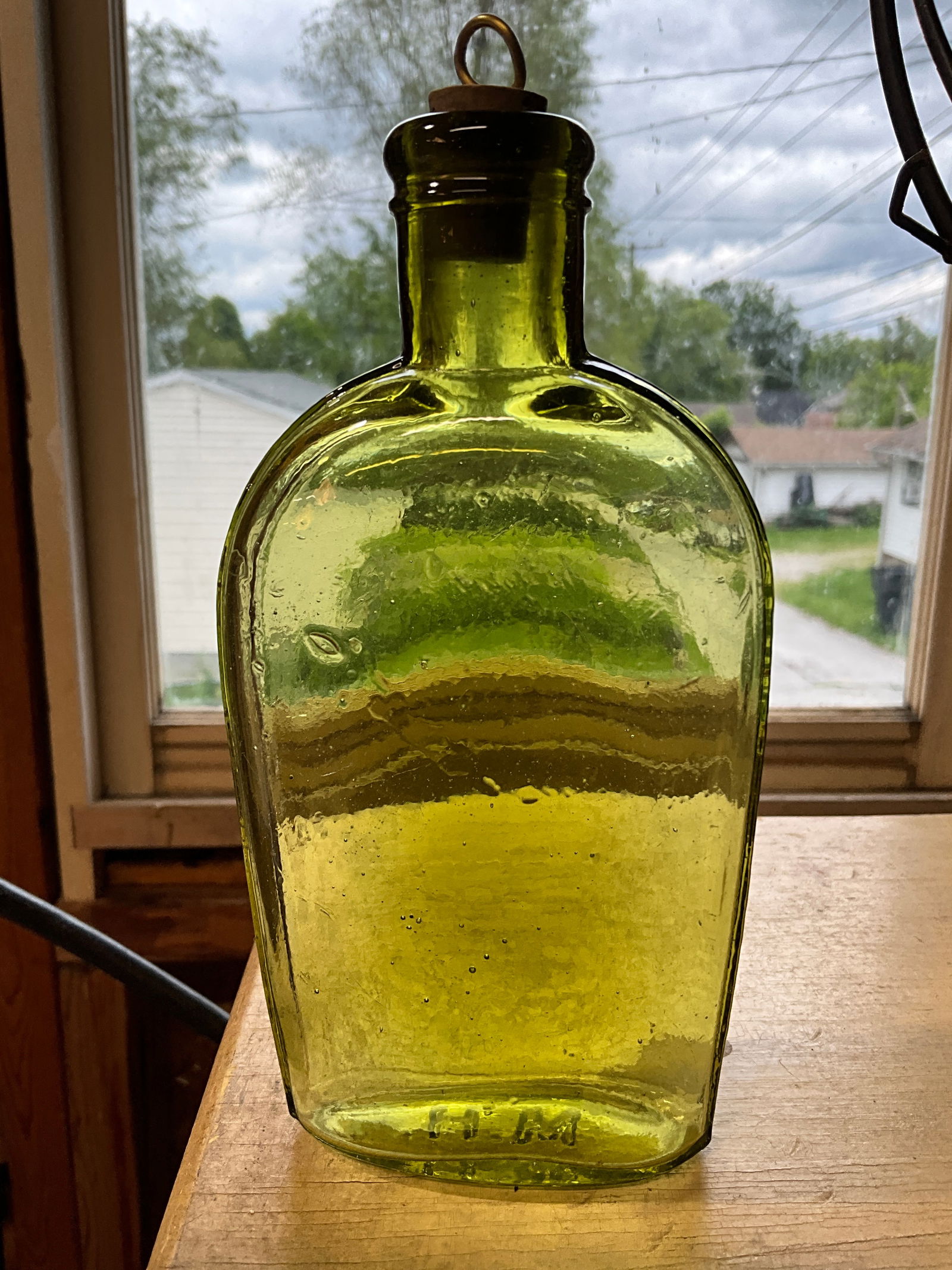 Olive Green  1/2  Pint Strap Sided Flask. Tooled Lip. "M.H." embossed one the base (1 of 6)