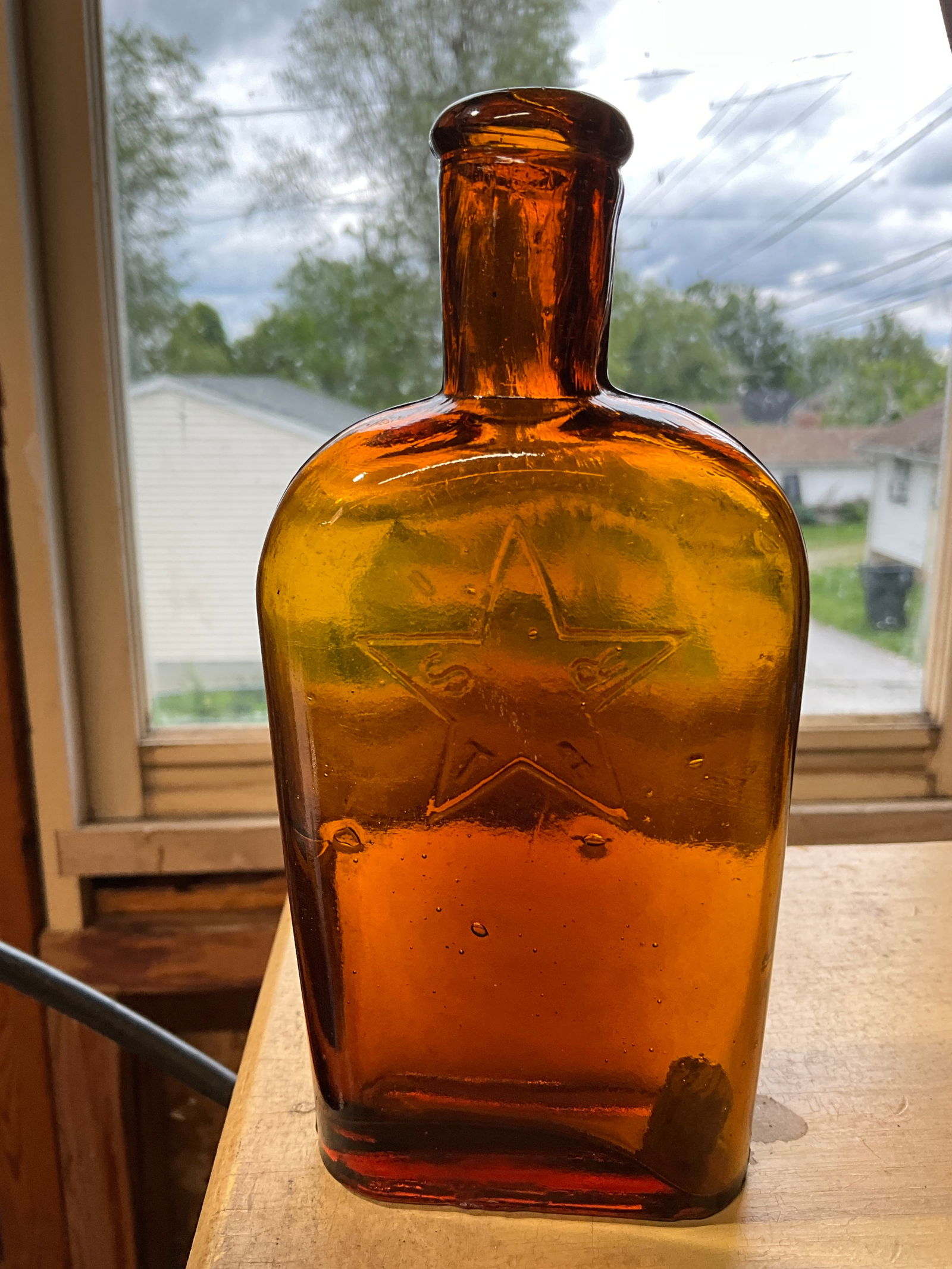 Amber 1/2 Pint Flask with an Embossed Star and embossed "STAR" in the middle of the star (1 of 6)