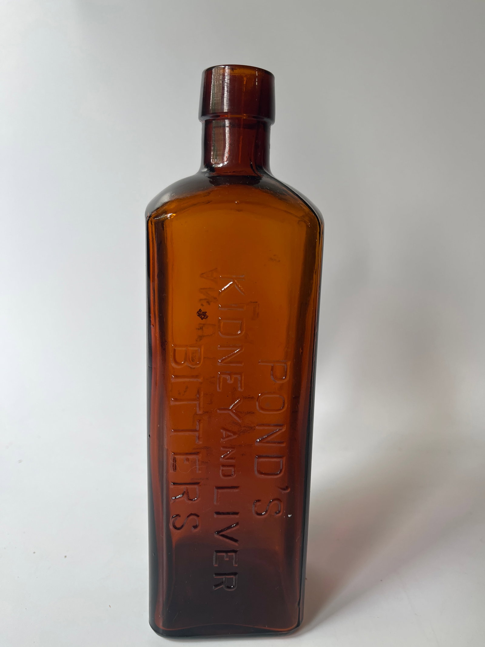 Pond's Kidney and Liver Bitters // An Unexcelled Laxative, amber: Here's a nice amber Pont's Kidney and Liver Bitters. This bottle is a lighter amber color and has no damage or stain.