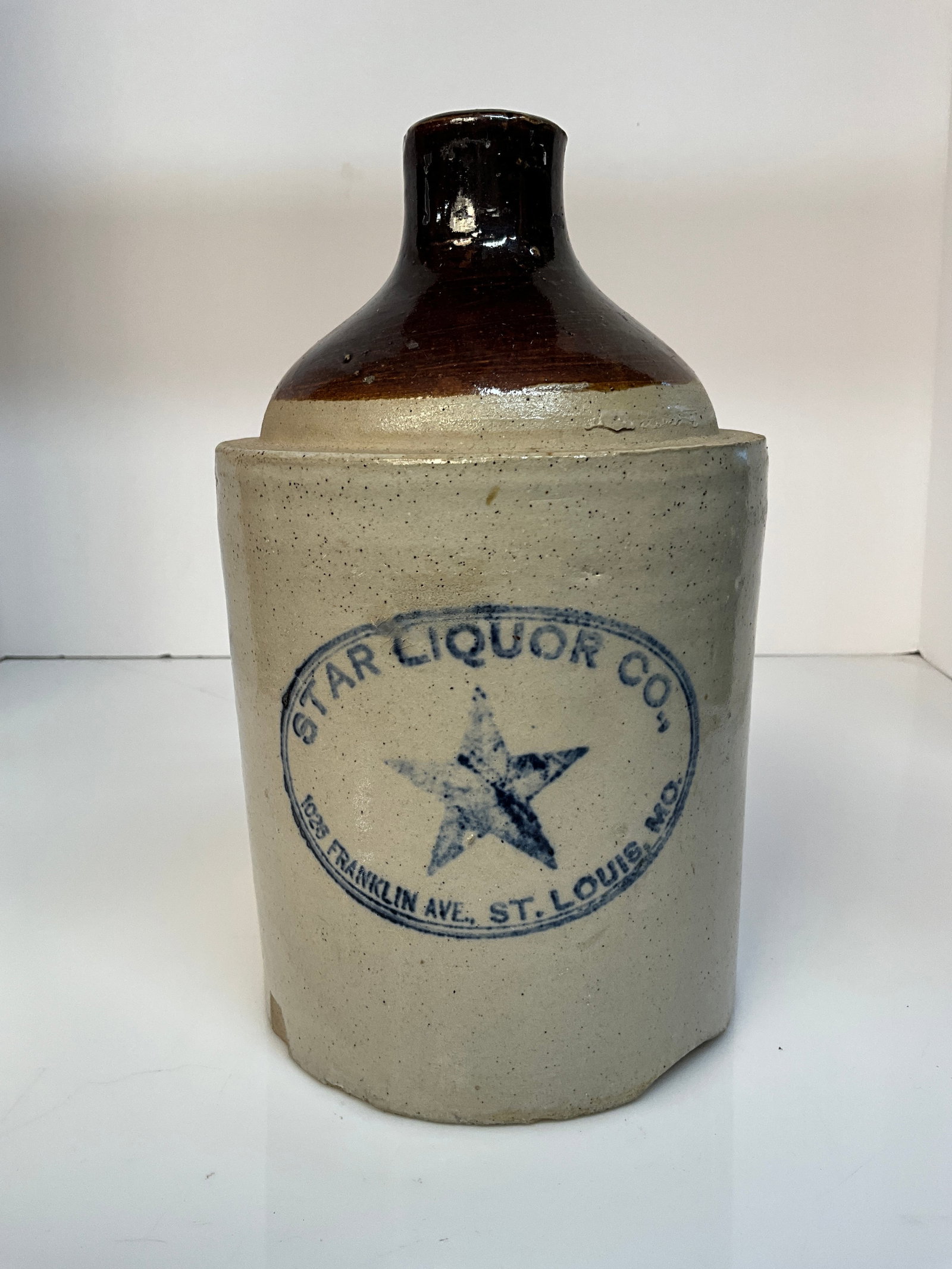 Small, Two-Tone Stenciled Whiskey Jug, Star Liquor Co., St. Louis: This is a small, two-tone stenciled whiskey out of St. Lous. The jug is a Star Liquor Co., jug, with address listed as 1026 Franklin Ave., St. Louis, MO. Large star stencil. The handle is in great sha