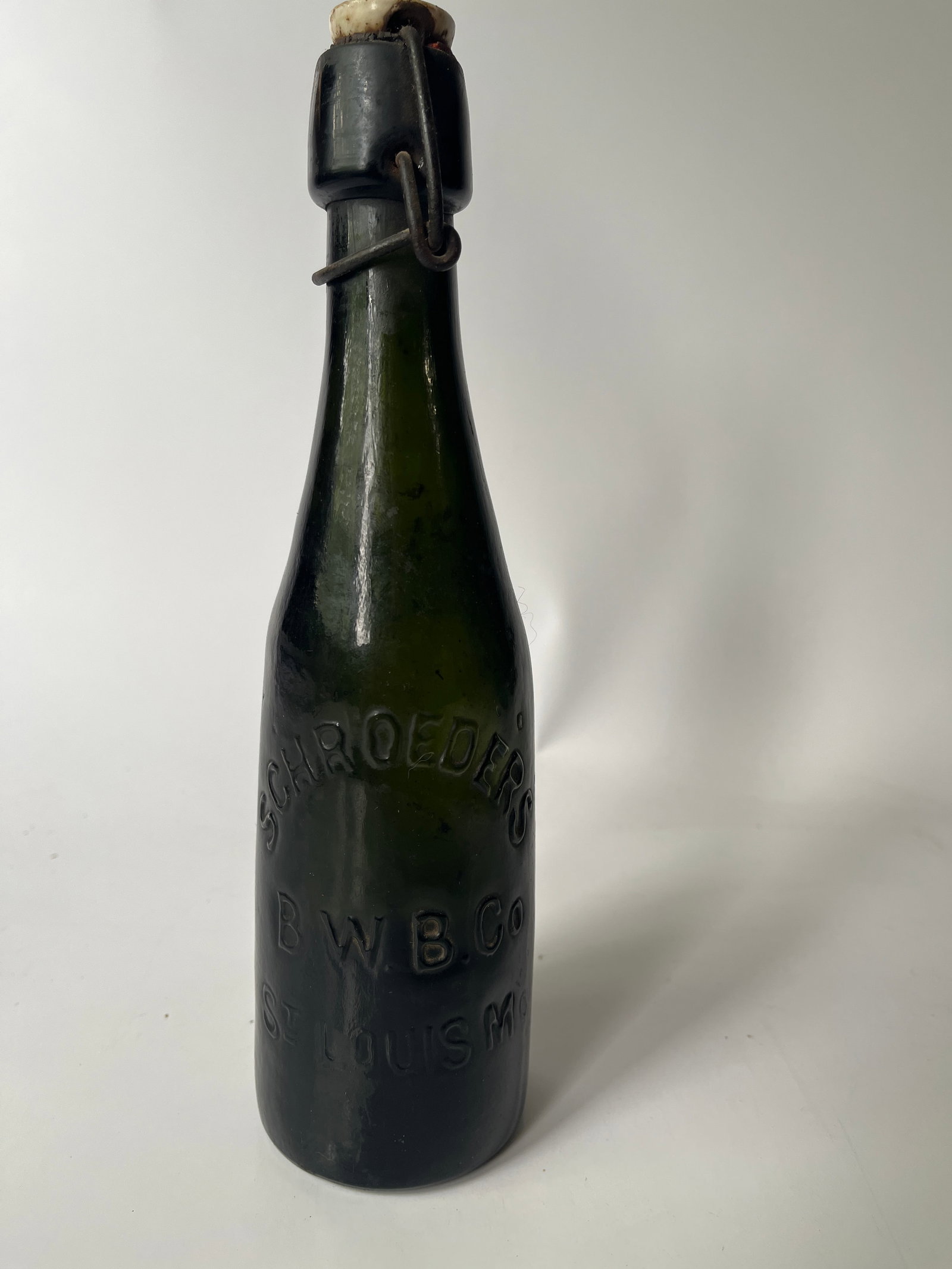 Schroeders B.W.B. Co St. Louis Mo dark green pint blob beer w/ bail.: Now we have a super crude pint blob beer that has the original bail and still has liquid inside. The bottle is a dark green color and is embossed Schroeders B.W.B. Co St. Louis Mo. There is now damage