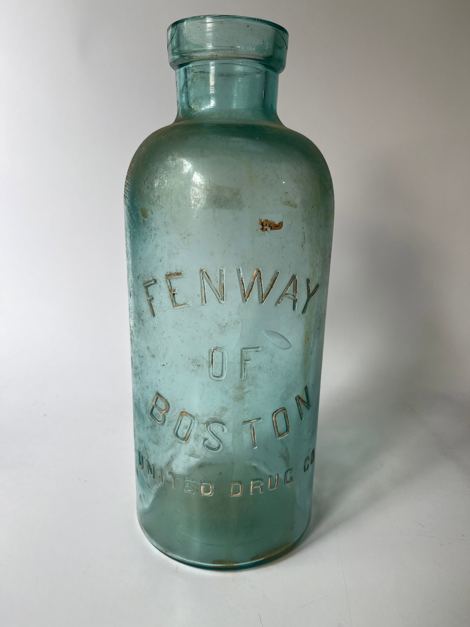 Fenway of Boston United Drug Co Stopper Jar: Here's a Fenway Of Boston United Drug Co. stopper jar. The jar stands 12" tall, probably holds a half gallon, and is aqua in color. There is no damage to the jar but it does need cleaned up.