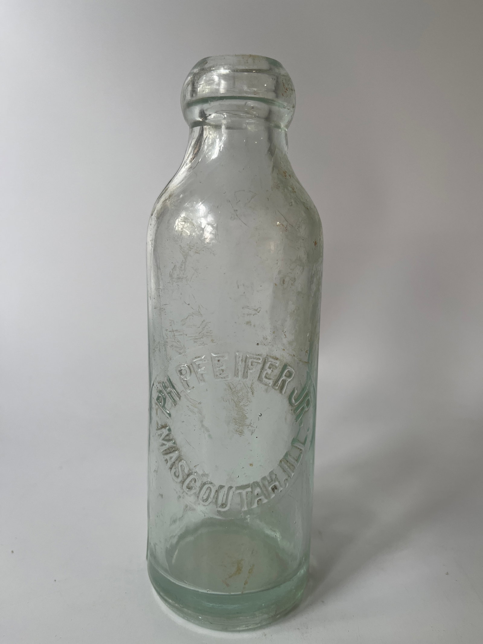 PH Pfeifer Jr. Mascoutah, Ill. hutch soda: Here is a nice PH Pfeifer Mascoutal, Ill hutch style soda. This bottle has a blob top similar to a hutch stopper but different. The bottle is a light aqua color and has no damage, just a touch of stai