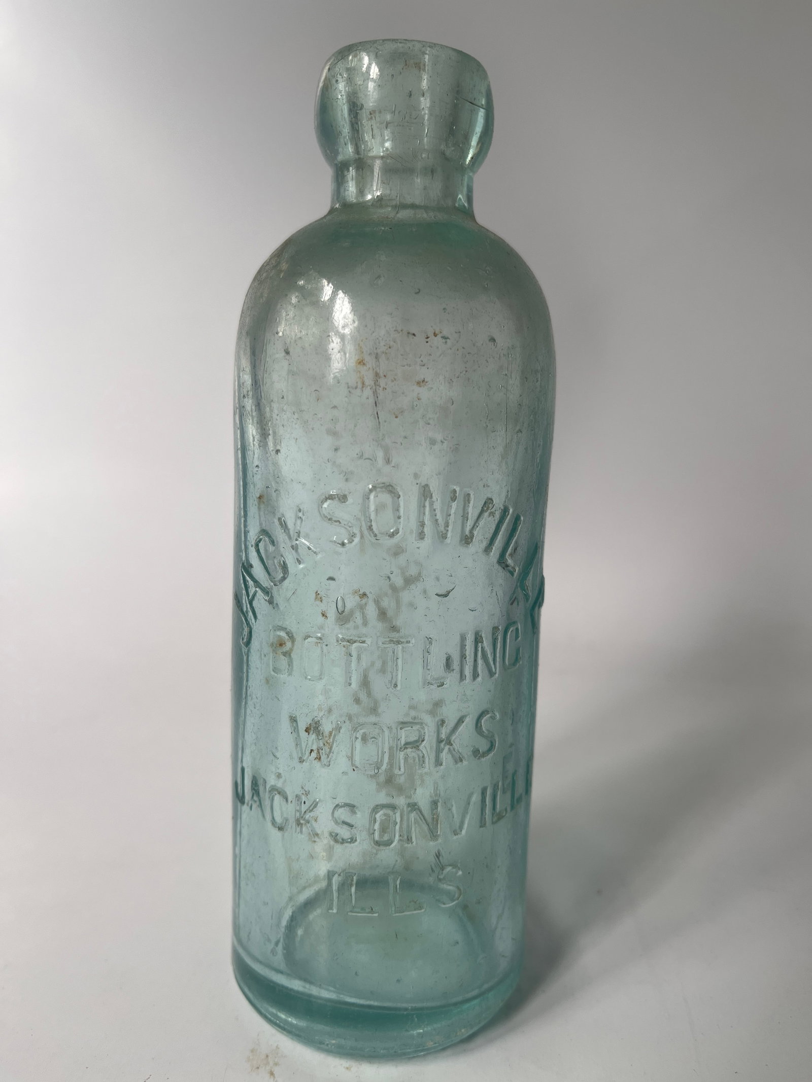 Jacksonville Bottling Works Jacksonville, Ills aqua hutch soda.: Here's a Jacksonville Bottling Works Jacksonville, Ills hutch soda. The bottle is aqua in color and has no damage. It could use a bath.