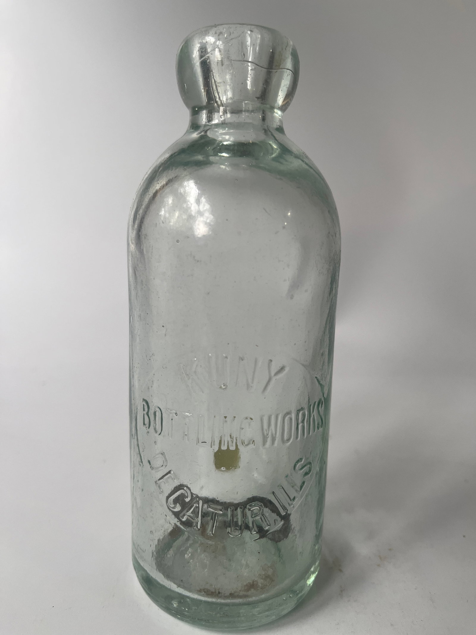 Kuny Bottling Works Decatur, Ills aqua hutch: Next up is a Kuny Bottling Works Decatur, Ills hutch soda. The bottle is aqua in color and has no damage or stain.