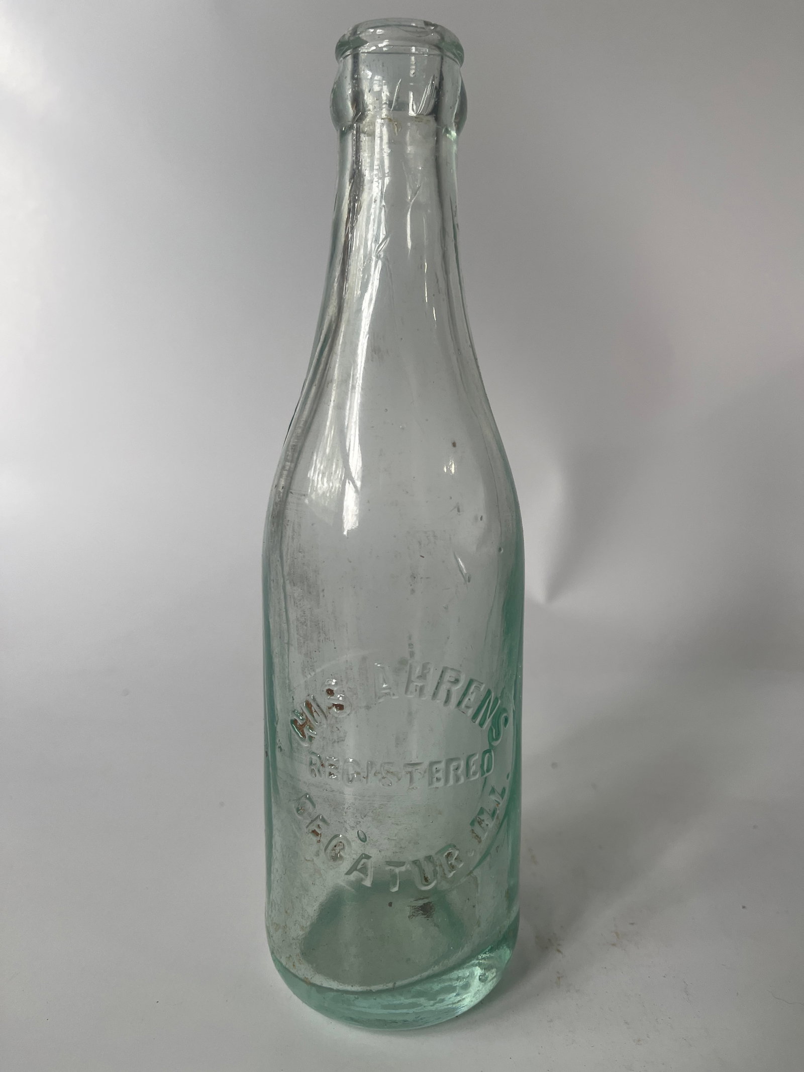 Gus. Ahrens Decatur, Ill. aqua crown top soda.: Here's a Gus. Ahrens Decatur, Ill crown top soda. The bottle is aqua in color and has no damage or stain.