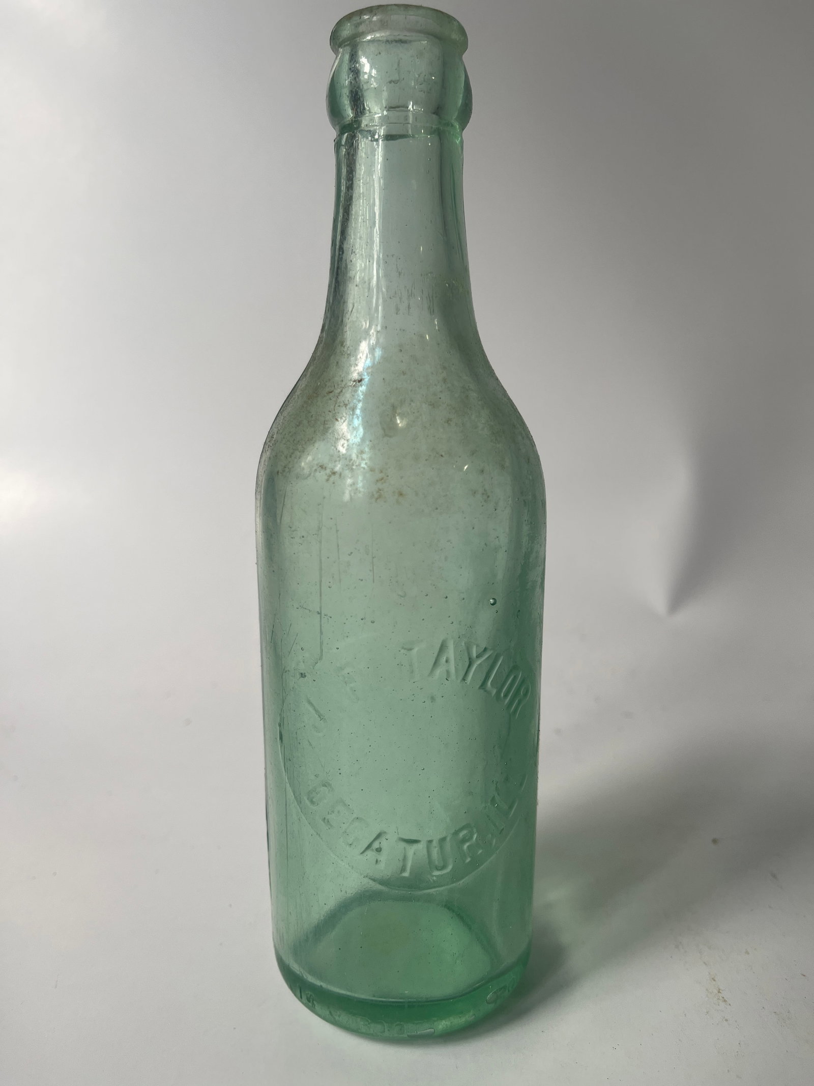 J.F. Taylor Decatur, Ill. aqua crown top soda.: Here's a J.F. Taylor Decatur, Ill crown top soda. The bottle is aqua in color and has no damage, just light stain.