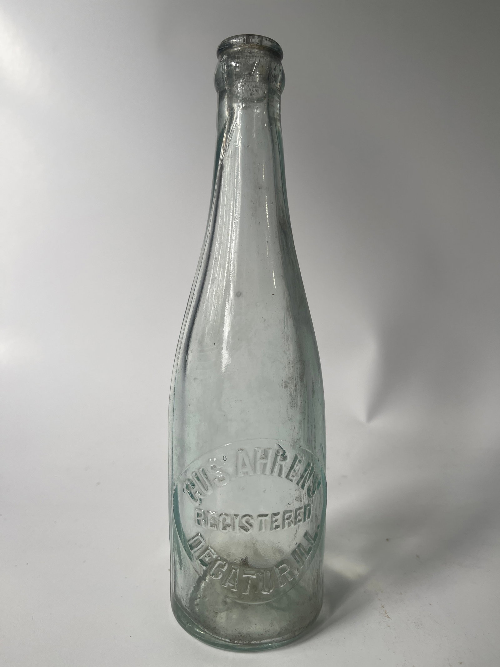 Gus. Ahrens Decatur, Ill. aqua crown top soda or beer.: Here's a Gus. Ahrens Decatur, Ill crown top soda or beer. The bottle is aqua in color and has no damage, just light stain.