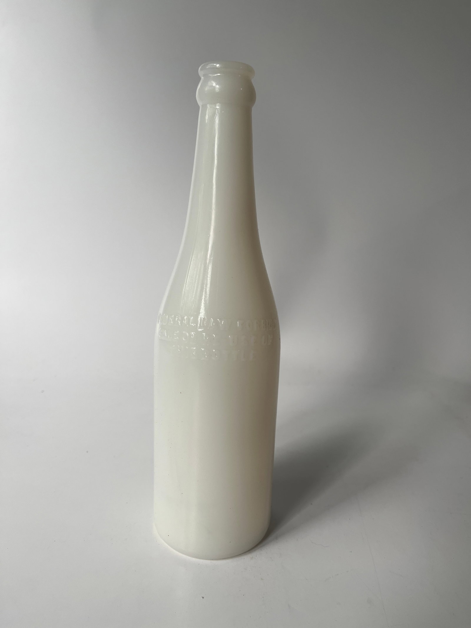 Milk Glass crown top beer bottle.: Here's a Milk Glass crown top beer bottle. It is embossed on the side with Federal law prohibits sale or re use of this bottle. It is embossed on the base with R-233 Mass WI-53. No damage or stains.