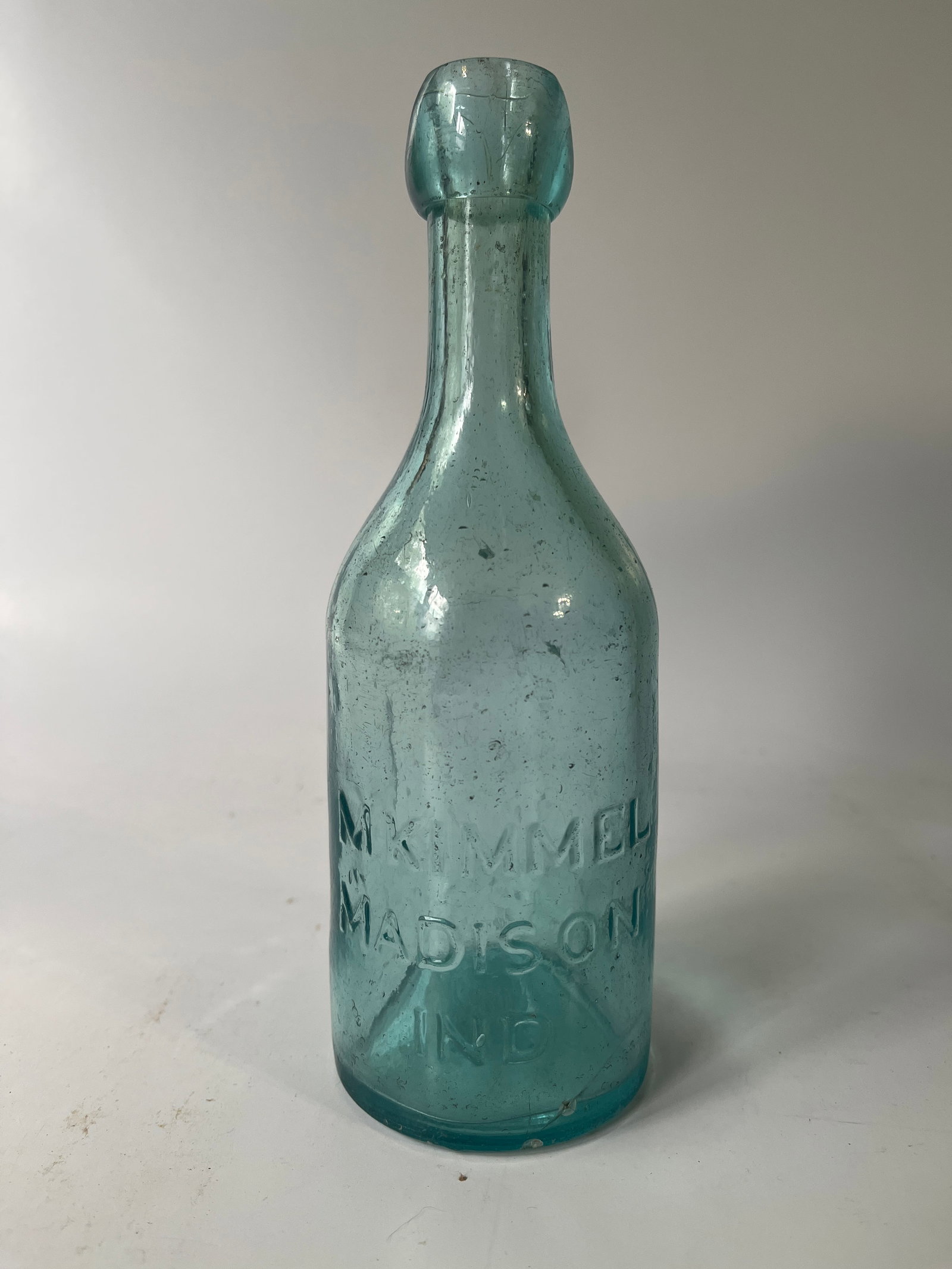 M. Kimmel Madison, Ind aqua blob soda: Here's a scarce M. Kimmel Madison, Ind blob soda. The bottle is aqua in color and has a small crack coming up from the heel. Rare bottle, great bottle and hard to get.