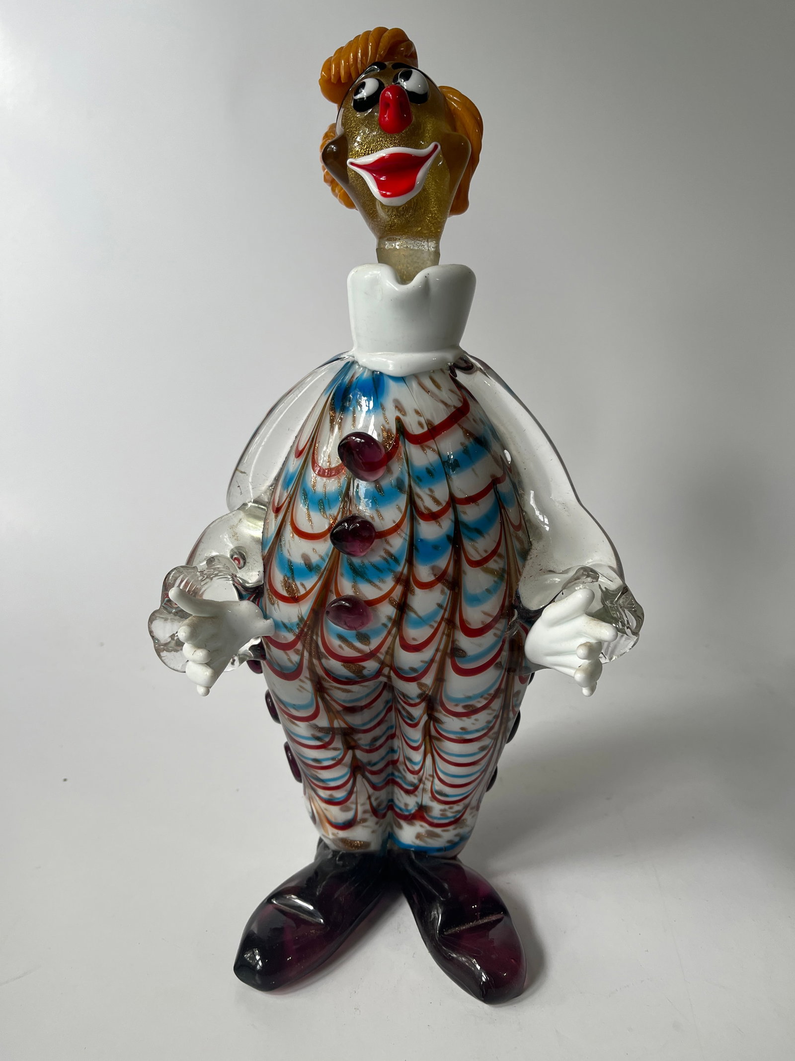 Art glass figural clown decanter, hand made.: Here is a odd figural clown decanter. The piece is hand made and probably involved a ton of work. It is layered with different colors of glass and has a stopper in the shape of a head. There is a tiny