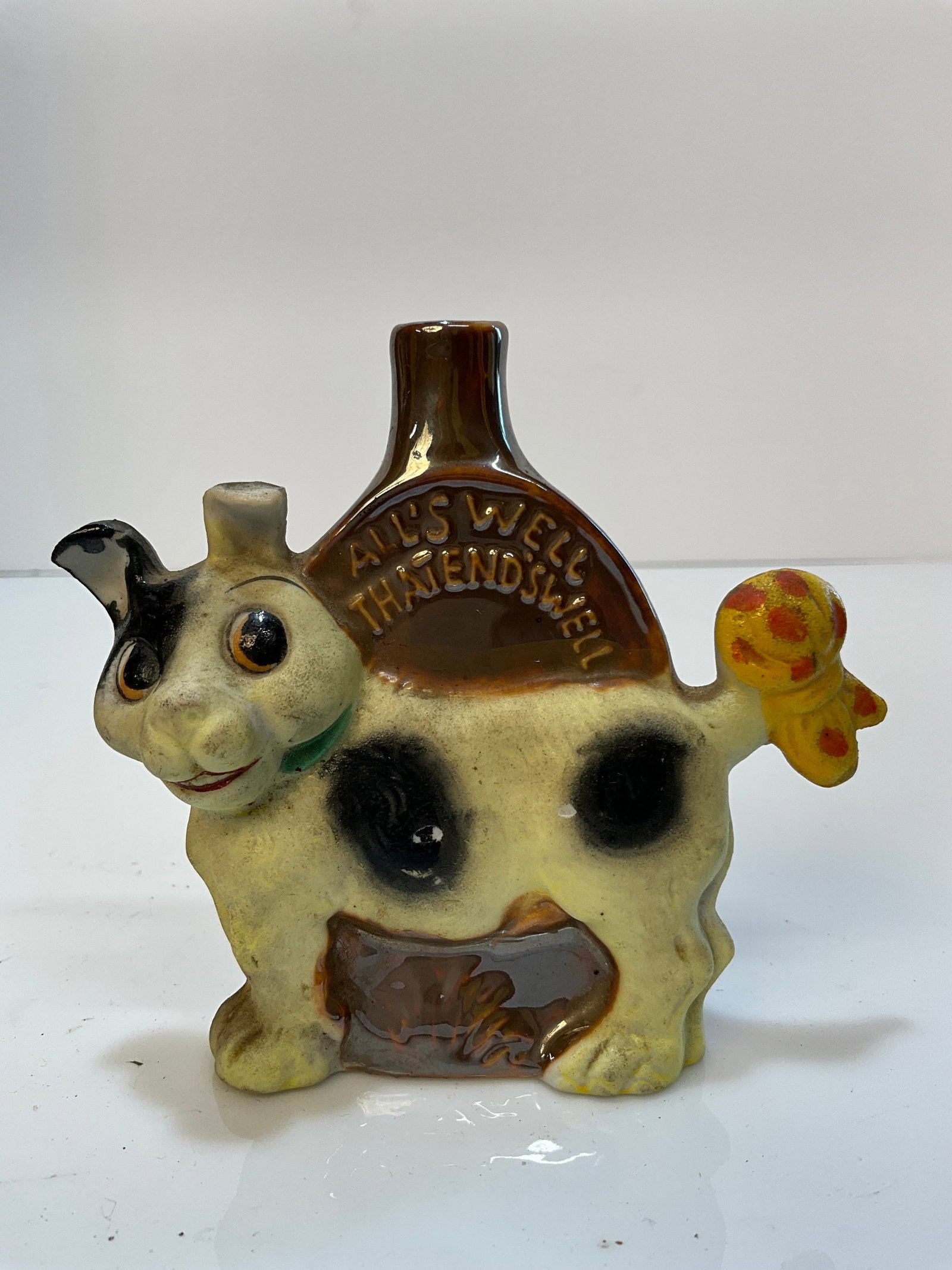 Vintage Whiskey Nip - Dog with Yellow Bowtie on its Tail, Porcelain, All's Well That End's Well: Vintage Whiskey Nip - Dog with Yellow Bowtie on its Tail, Porcelain, All's Well That End's Well, Made in Japan. no stopper and cork is stuck in neck.