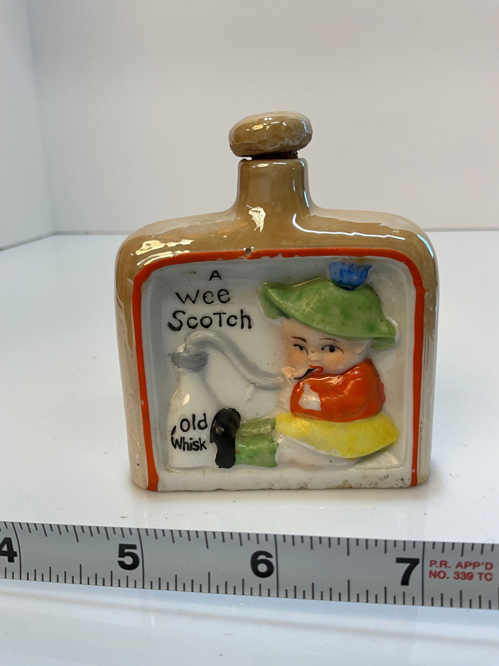 Vintage Whiskey Nip - Baby Drinking out of a Bottle of Old Whiskey, "A Wee Scotch" - Made in Japan.: Vintage Whiskey Nip - Baby Drinking out of a Bottle of Old Whiskey, "A Wee Scotch" - Made in Japan. Cute baby drinking what appears to be milk but says whiskey instead.