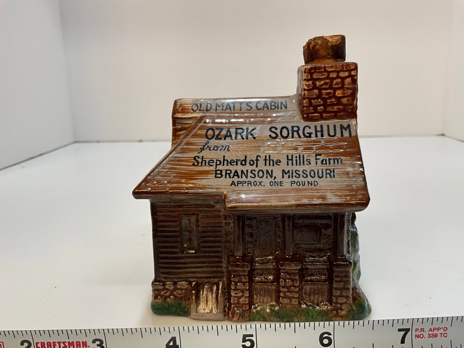 Pottery Log Cabin, Old Matt's Cabin Ozark Sorghum - Hills Farm, Branson Missouri: Pottery Log Cabin, Old Matt's Cabin Ozark Sorghum - Shepherd from the Hills Farm, Branson Missouri, One Pound. I believe there is some Sorghum still in this container.