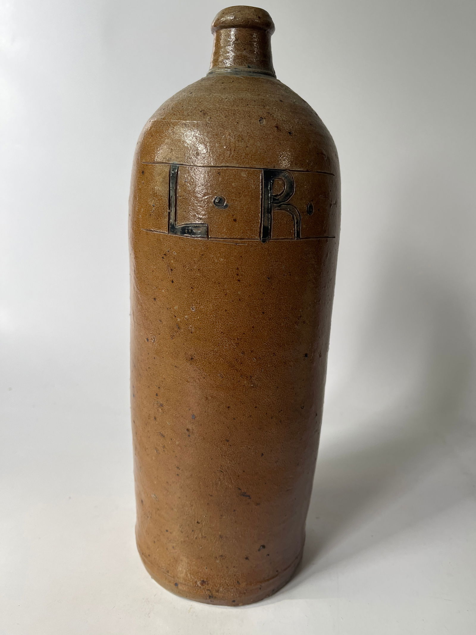Tall stoneware handled bottle w/ incised and blue colored L. R. letters. (1 of 4)