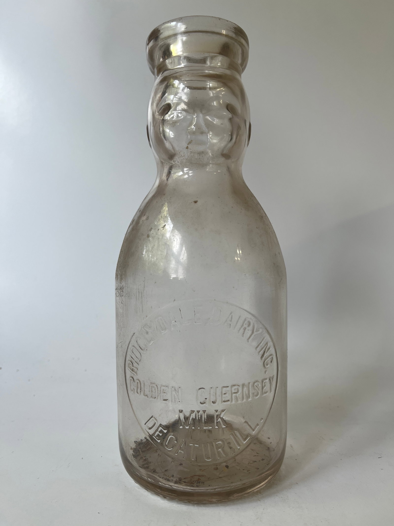Ridglydale Dairy Inc. Golden Guernsey Milk Decatur, Ill baby face quart.: Here's a Ridglydale Dairy Inc. Golden Guernsey Milk Decatur, Ill baby face quart. The jar has no damage but some mild stain.