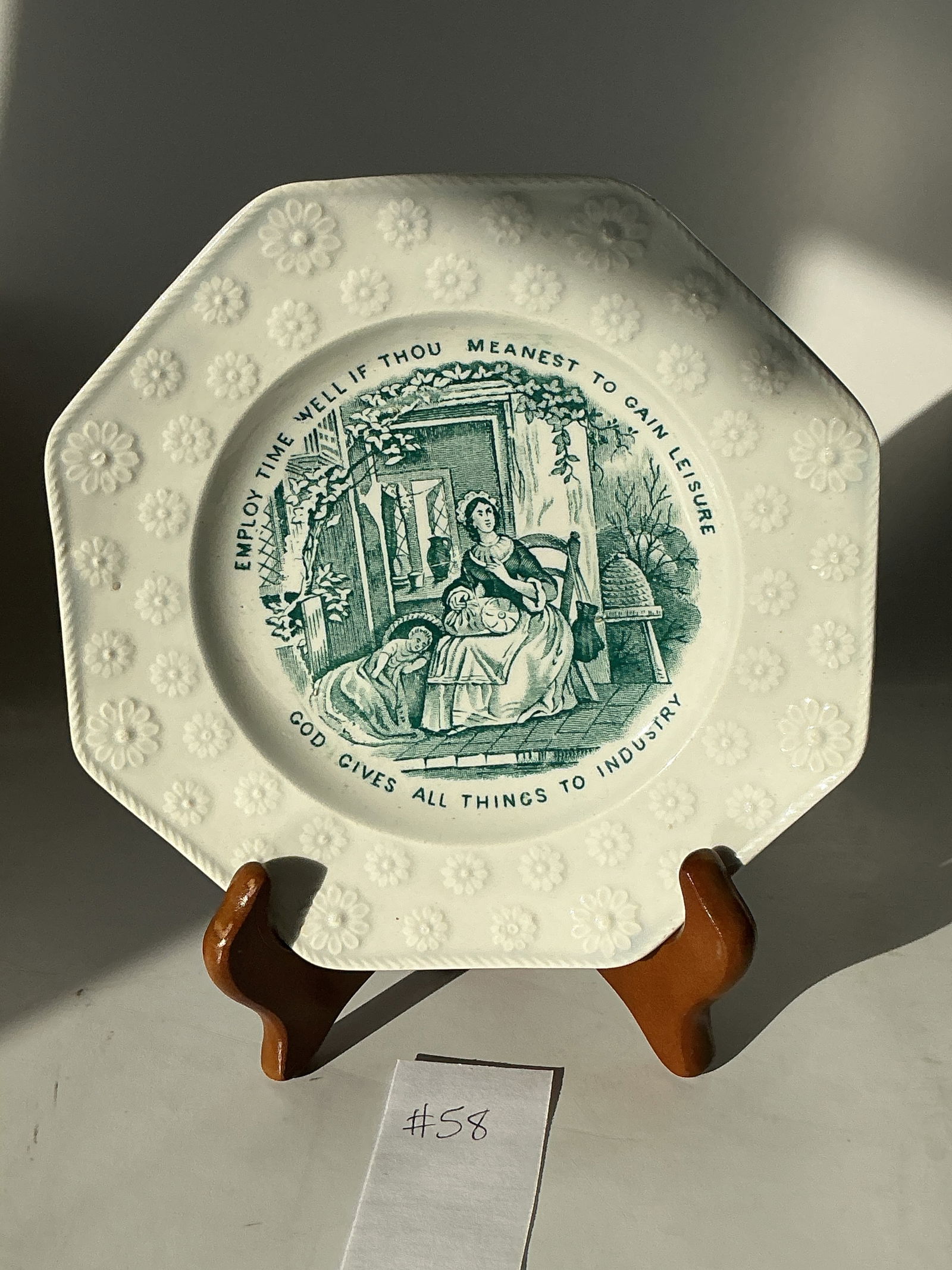 Octagonal Franklin Maxim Plate: Eight sided 6 1/2" plate with blue green transfer print, two sayings and embossed floral border. The seated mother has a lace making pillow in her lap. Probably 1845-1855. In very good condition.