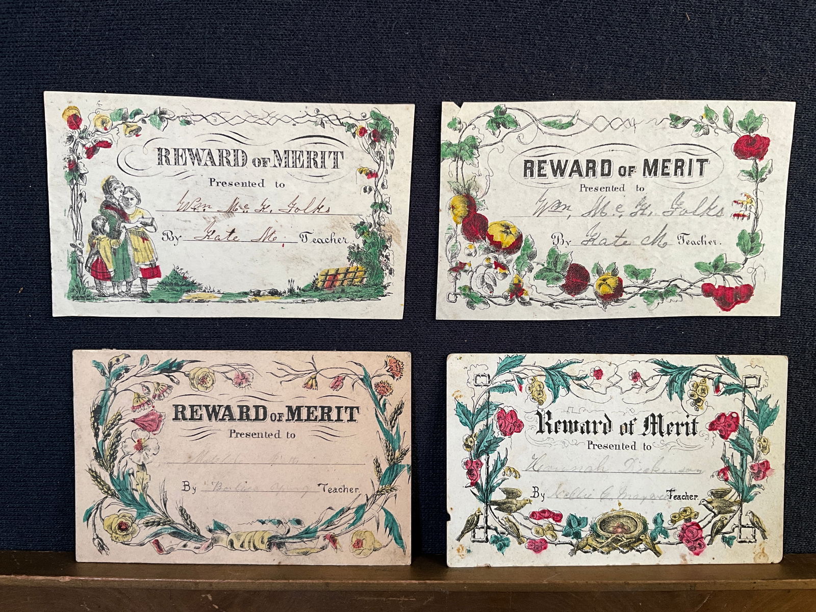 Rewards of Merit, ca. 1850s Lot of 4 - Floral and Fruit Borders Enhanced with Color: These four 1850s rewards feature floral or fruit borders enhaced with water color. Two are printed on stiff rag paper. The others on a glazed stock. They measure 2 ¼” x 3 1/2” ; con