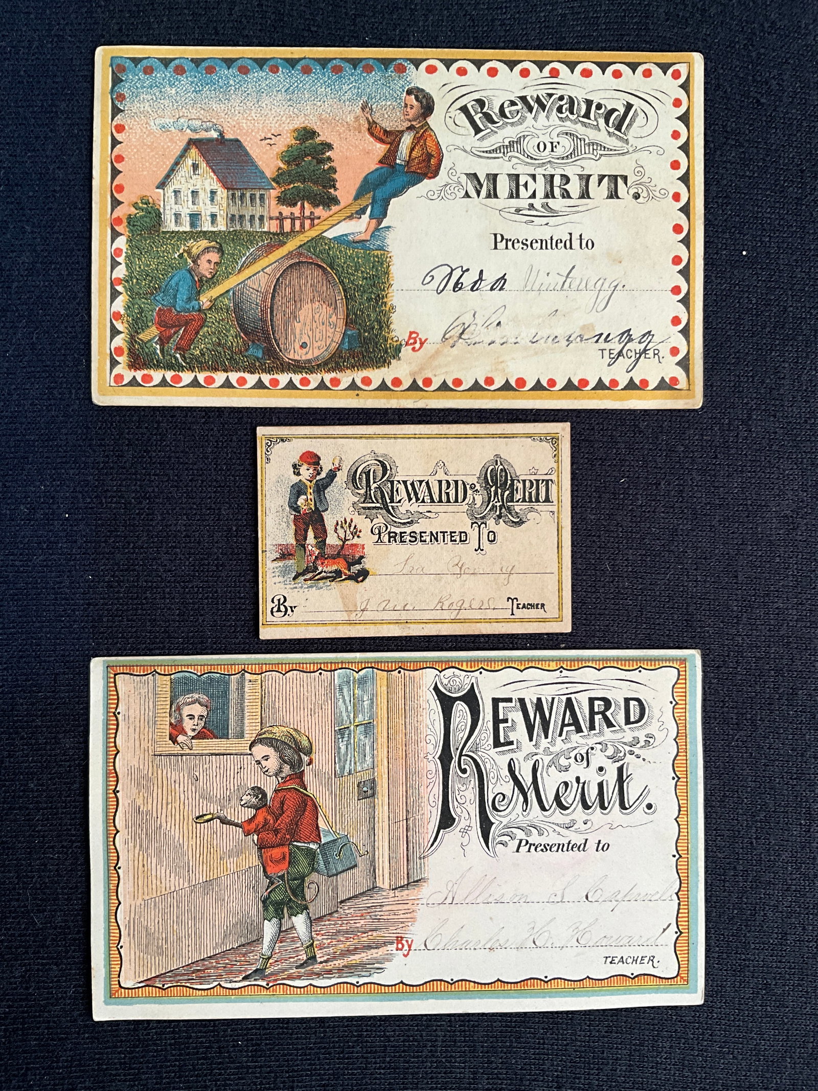 Rewards of Merit, ca. 1860 – 1880s Lot of 3 - Chromolithographs with Rather Fancy Artwork!: These three ca. 1865 – 1880s cards are chromolithograph with rather fancy artwork. The card with 2 boys on the teeter totter is 3” X 5”. The teacher’s name is partly rubbed away. Condi